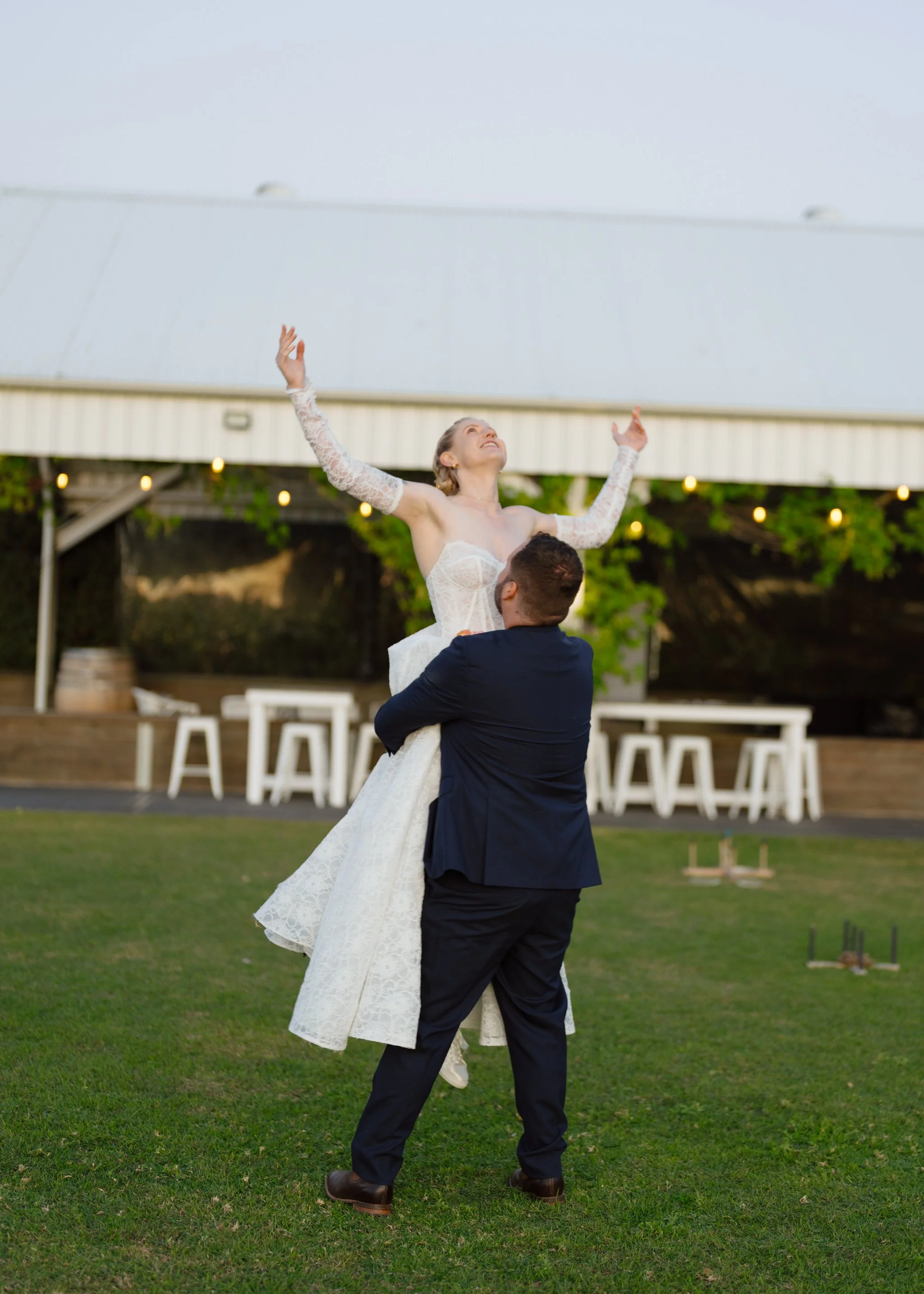 Groom Lifting the Bride on the Lawn