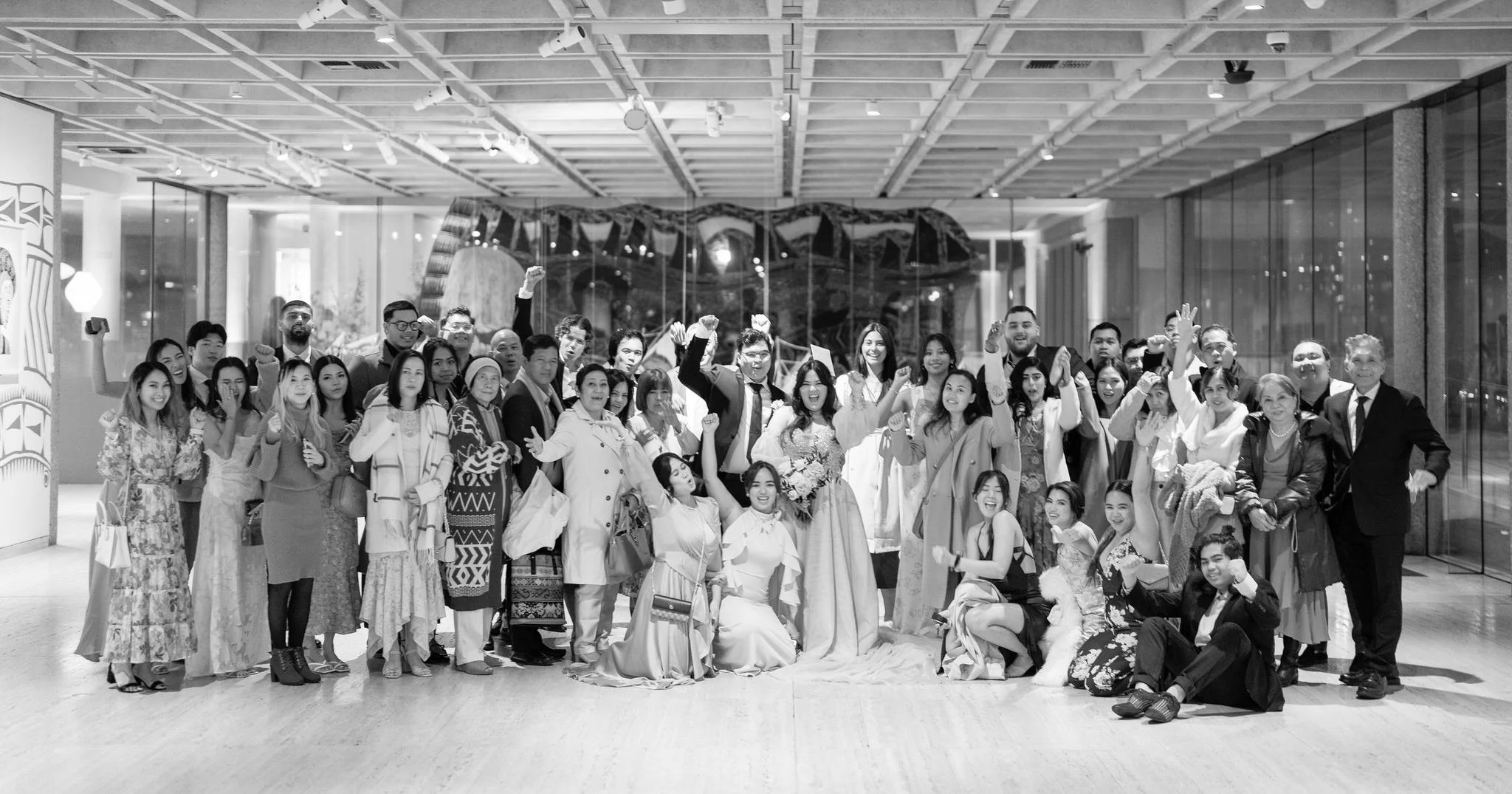 Bride and groom celebrate with wedding guests in a joyful group portrait at their Art Gallery Sydney wedding, photographed by Hunter Valley wedding photographer.