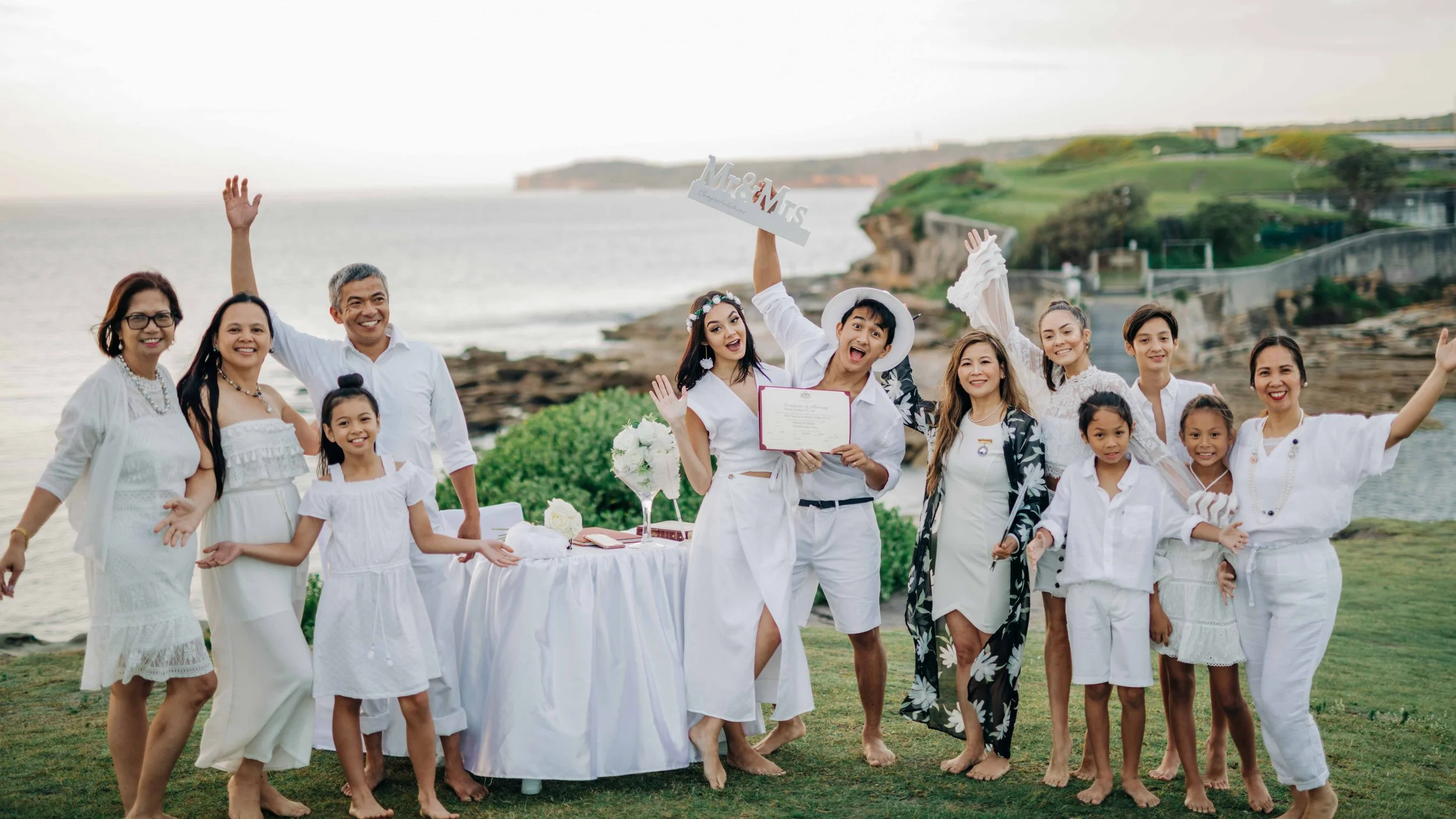 A group shot wedding of the newly-weds Makisig and Nicole in La Perouse New South Wales.
