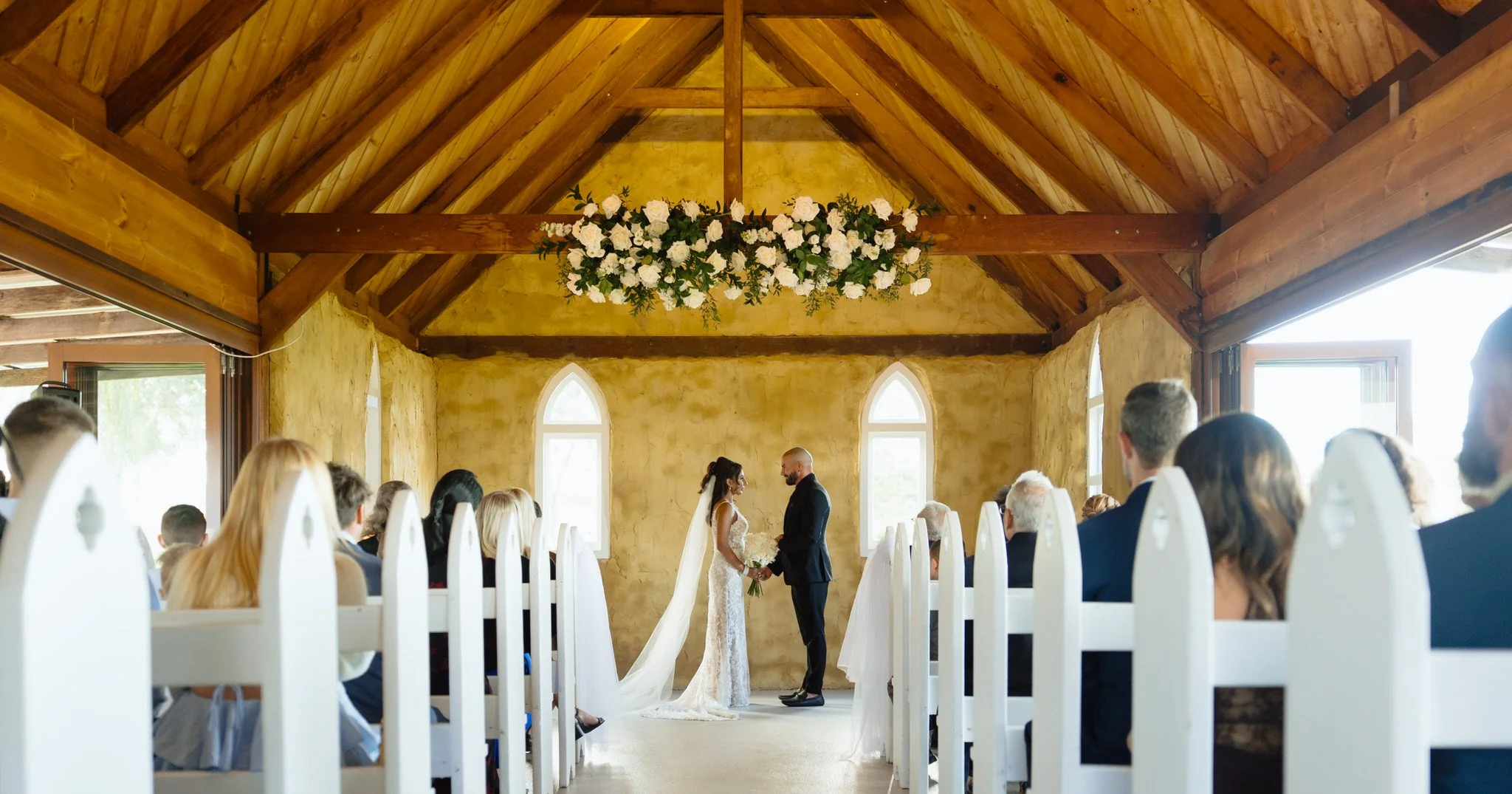 Bride and groom standing together during ceremony at Peppers Creek Chapel
