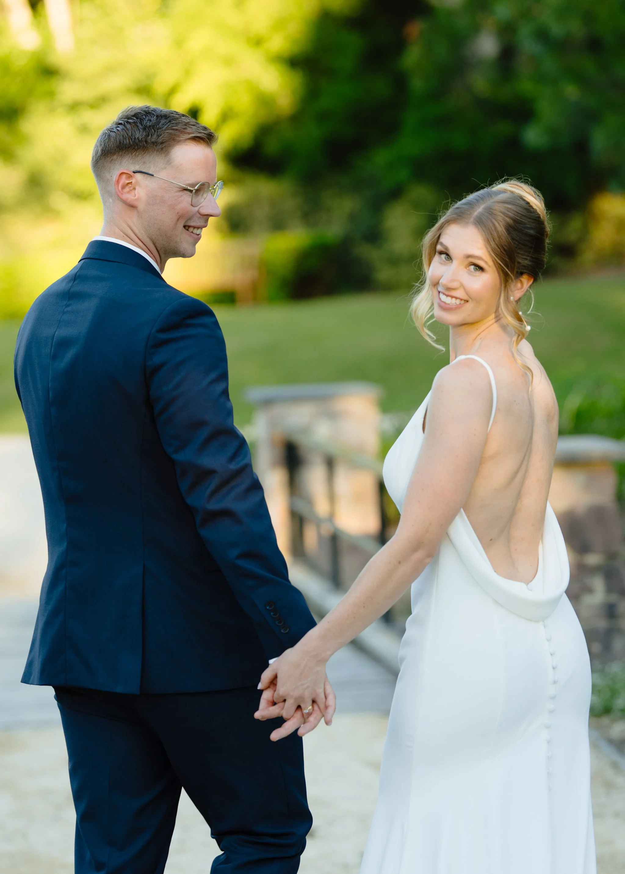 Couple holding hands and walking together during engagement session at Hunter Valley Gardens in Pokolbin