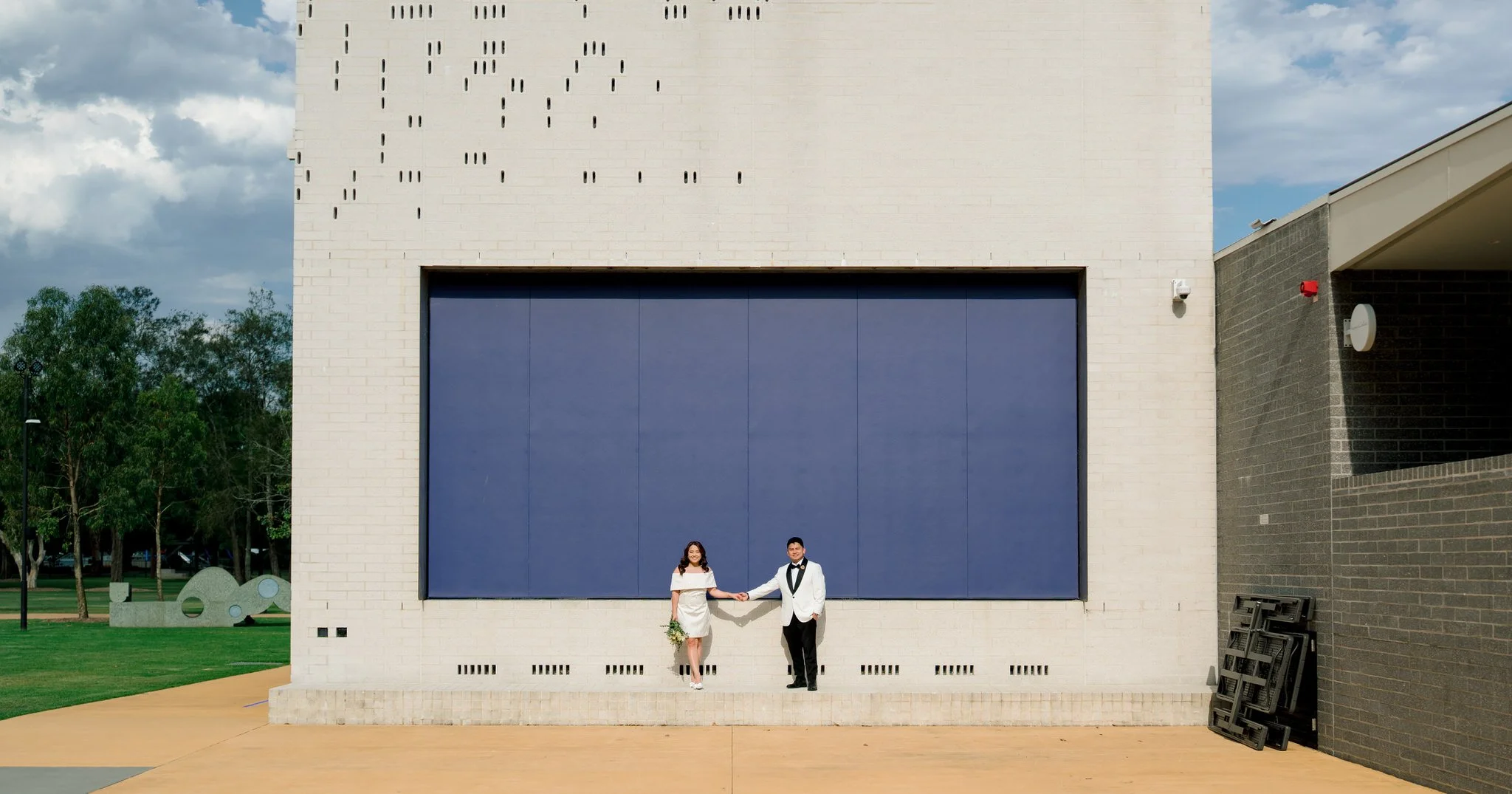 Post wedding portrait at Speers Point Park modern buildin