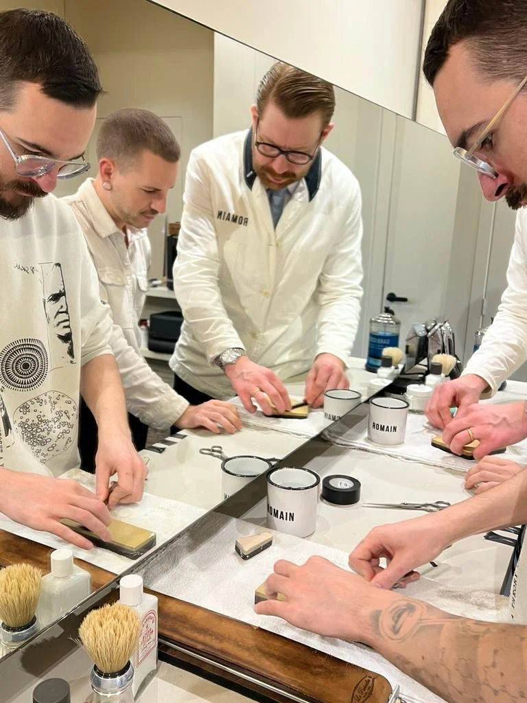 Stijn explaining honing techniques to a group of barbers.