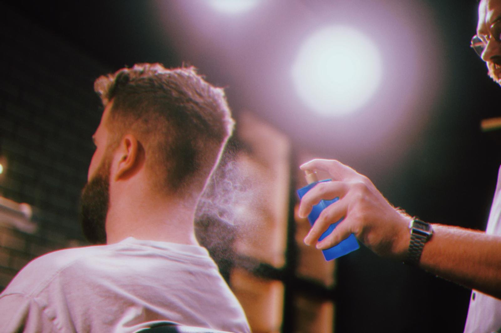 A barber at work inside ROMAIN Ghent