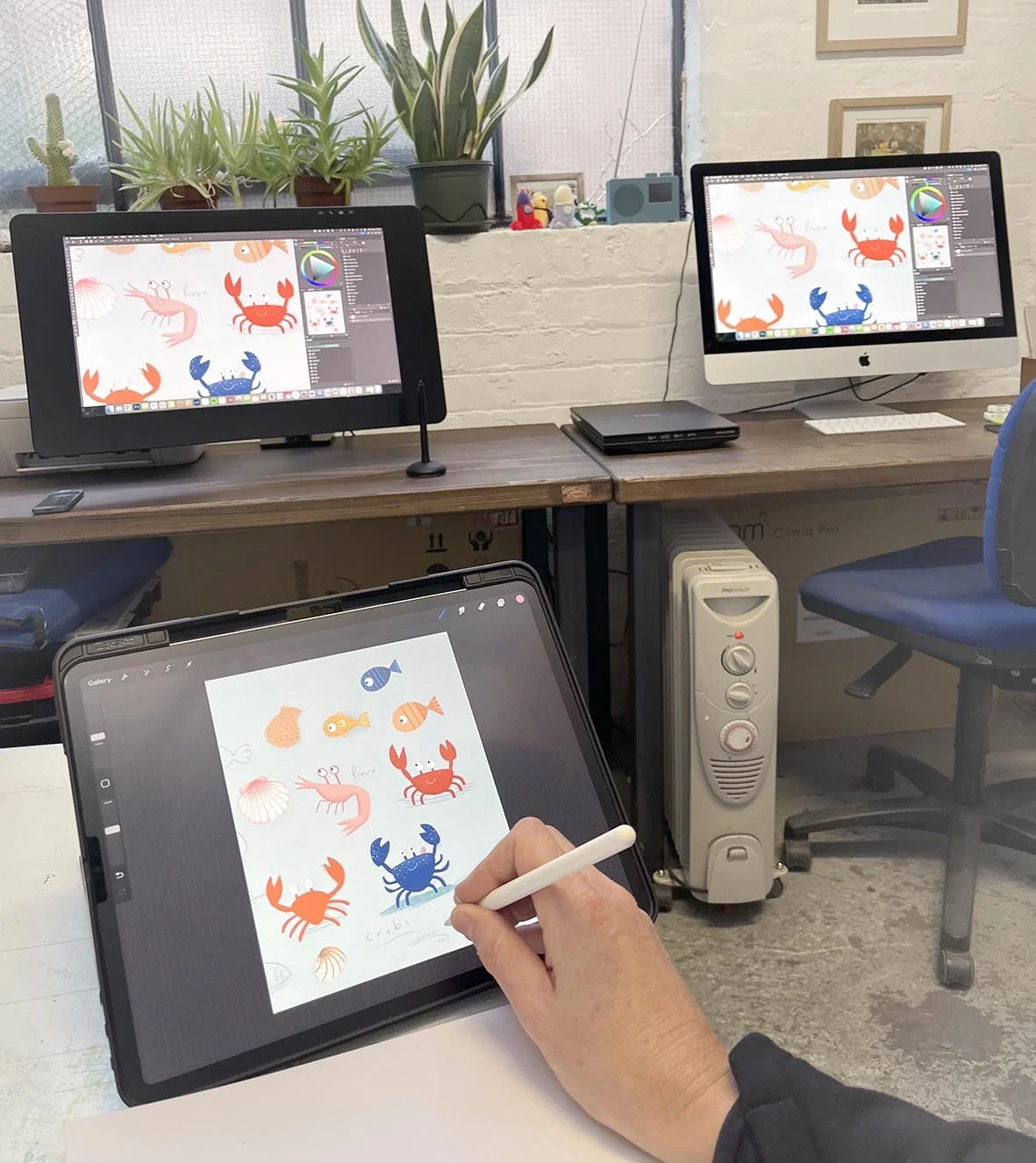 artist working in studio on digital illustrations for hospital murals