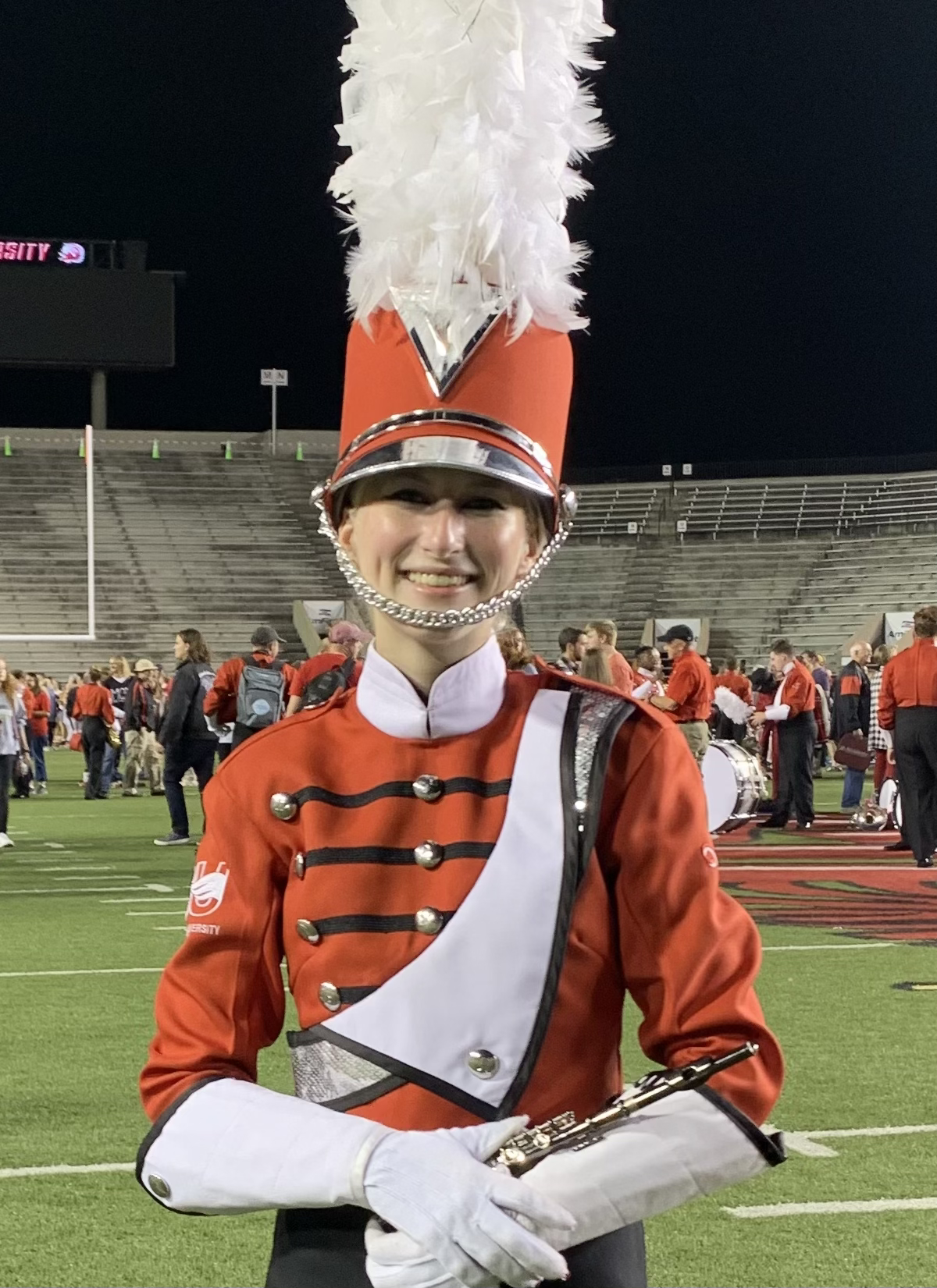 a person in a red and white marching band uniform
