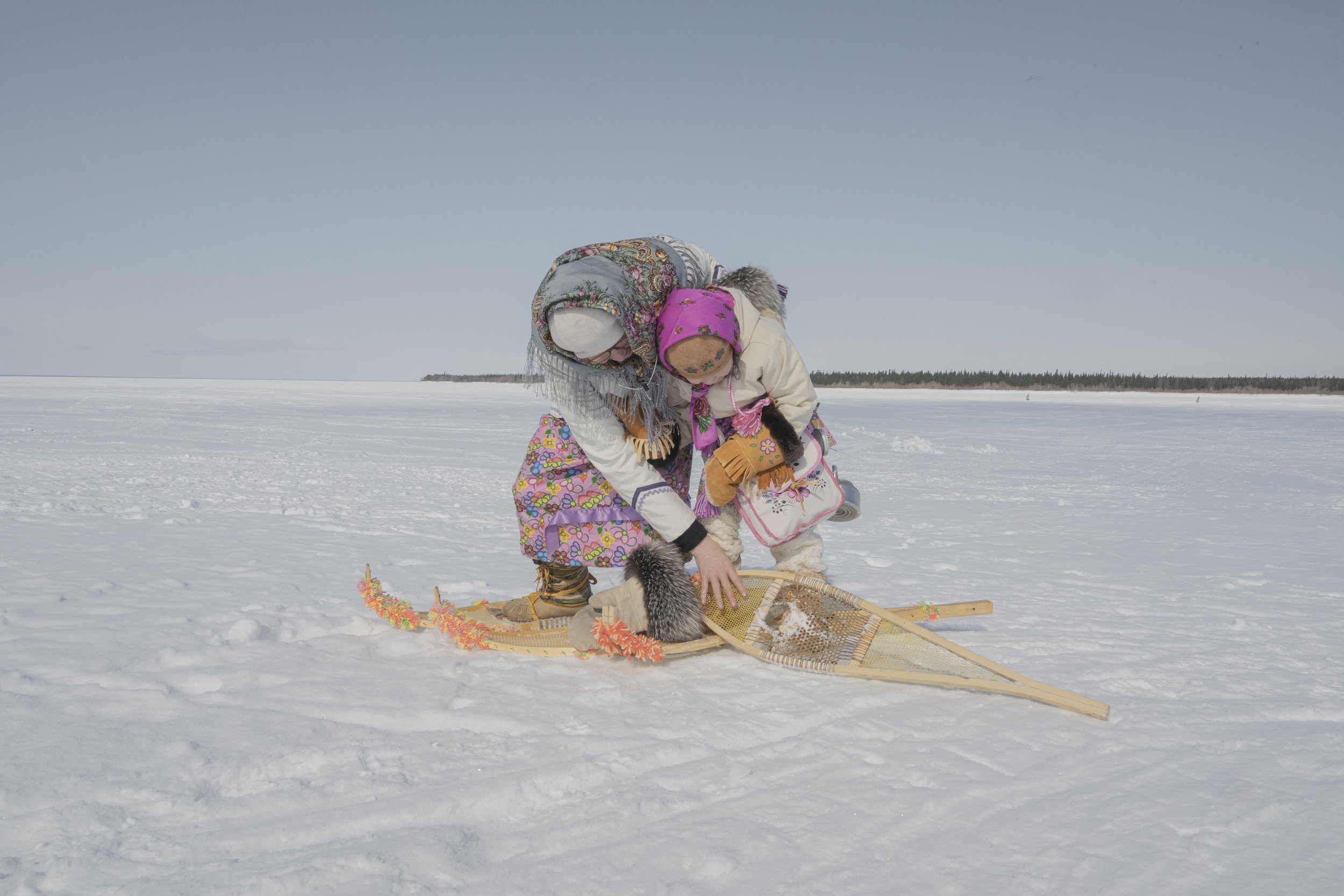 Receiving help from an Elder during a snowshoe walk.