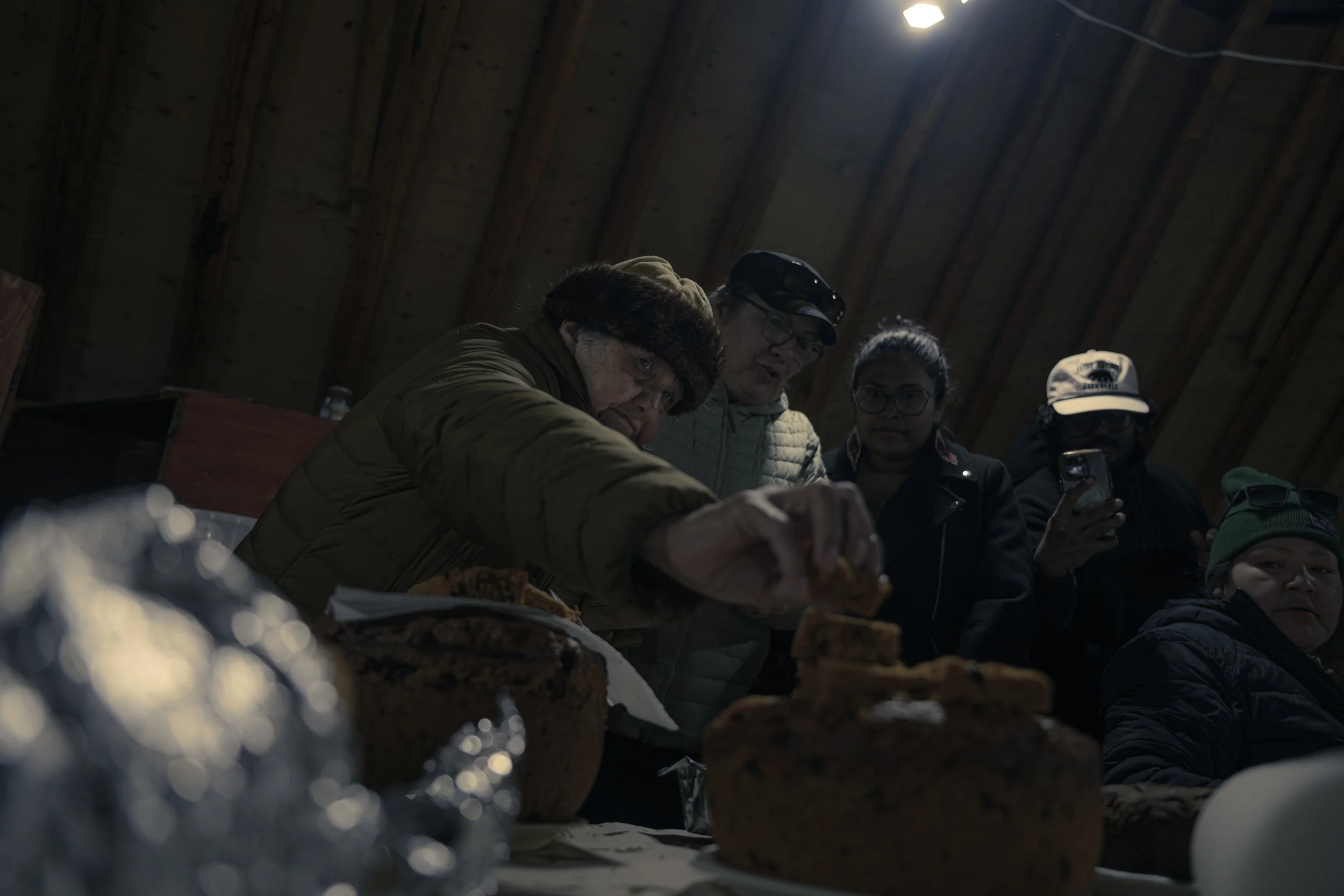Gathering for traditional foods inside the cooking tent.