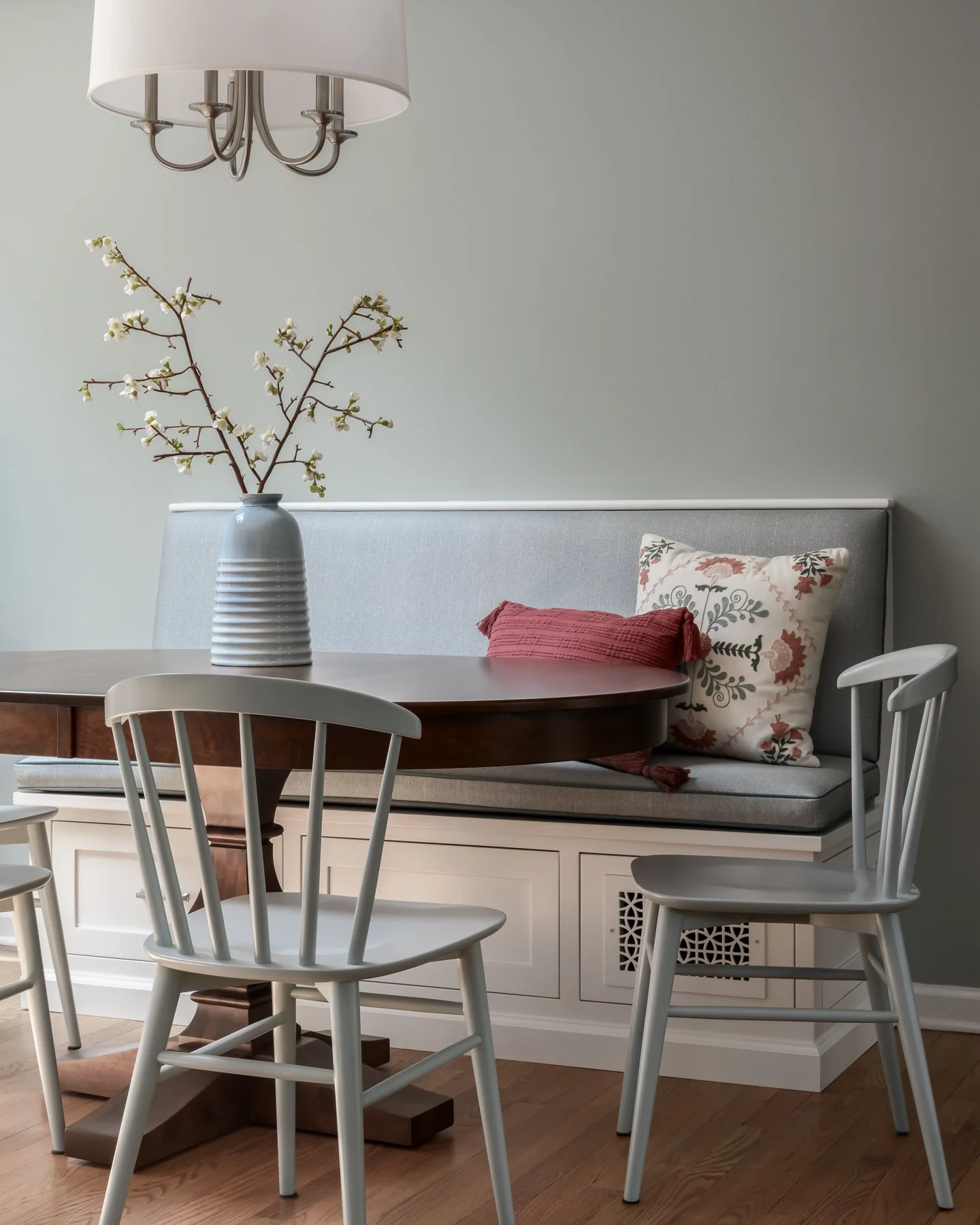 A cozy nook designed for real life.
This custom banquette was built to add both seating and storage, with wipeable vinyl fabrics that can handle kids and everyday life. I pulled everything together &mdash; from the banquette design to the chairs, pil