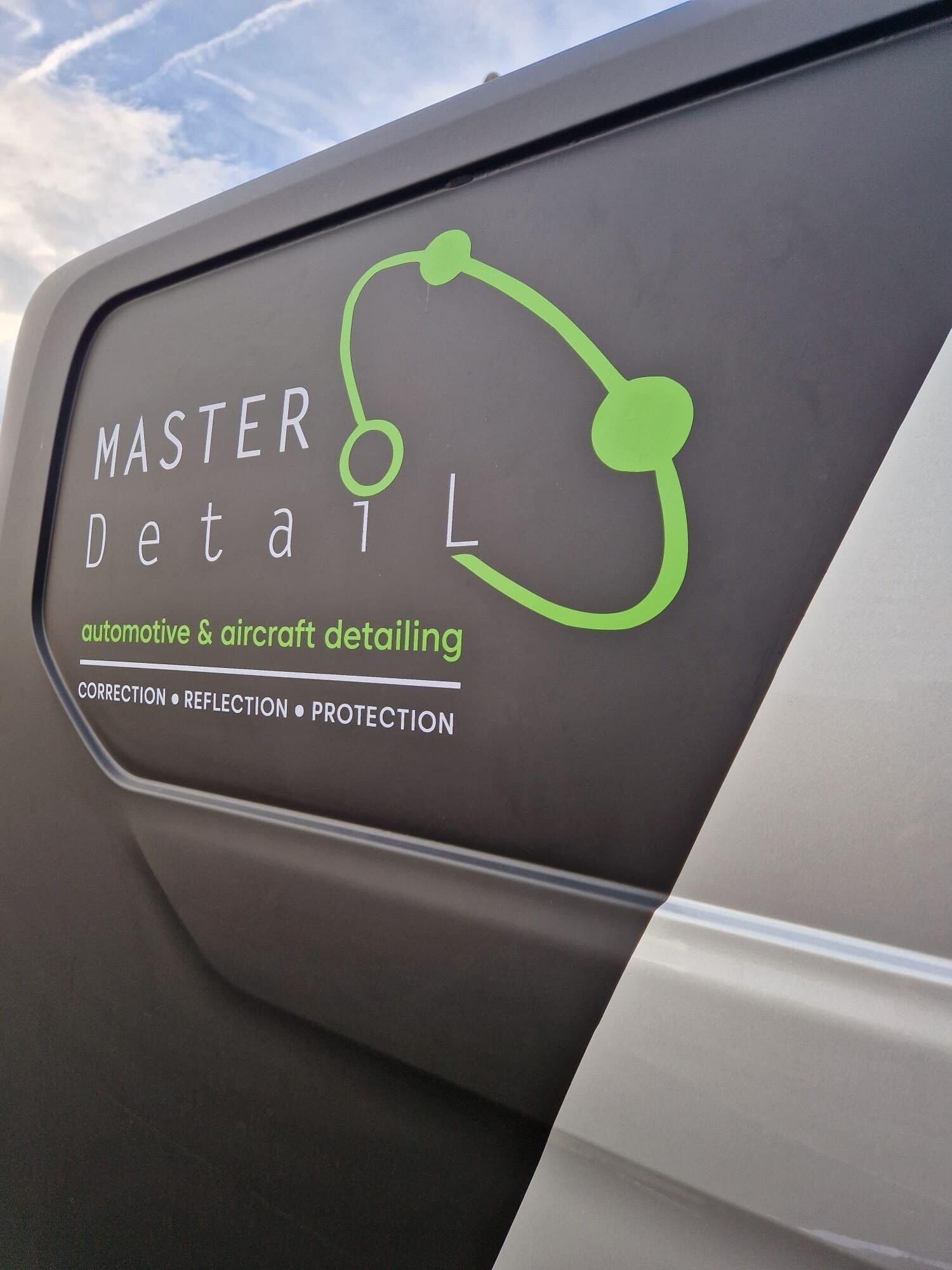 Sign for Master Detail automotive and aircraft detailing service with a logo of a stylized car outline and the words 'correction', 'reflection', 'protection'.