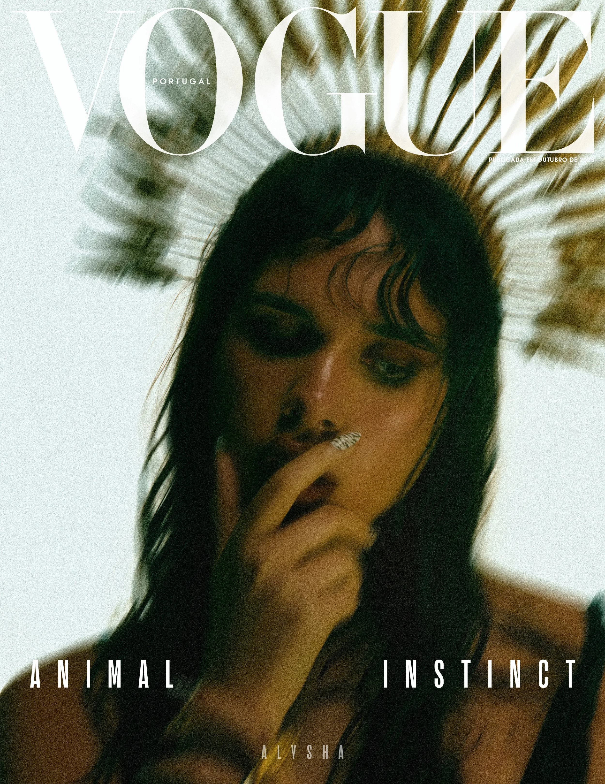 Vogue magazine cover featuring a woman with dark makeup, long dark hair, and a palm leaf headdress, with the words 'Animal Instinct' and 'Alysha' on the cover.
