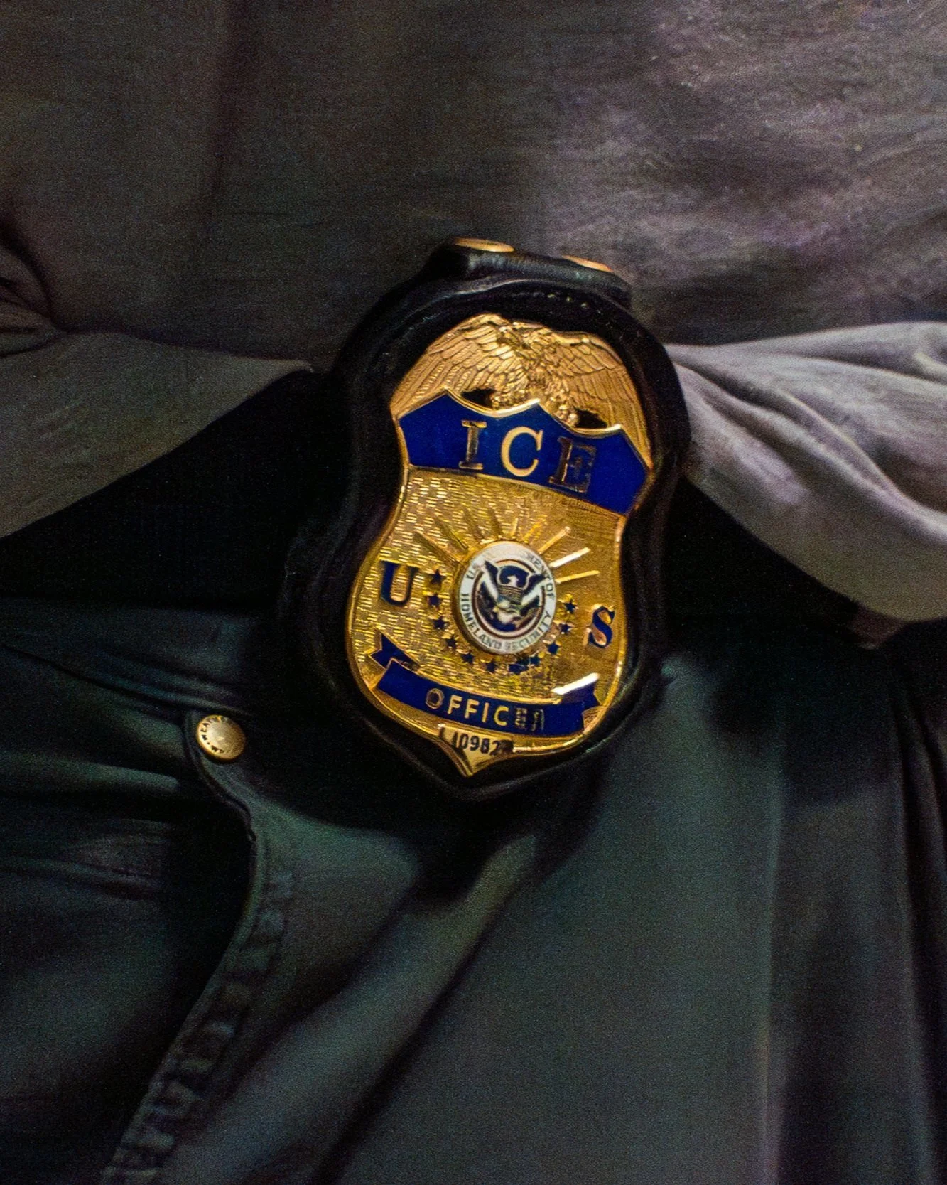 The badge worn at the hip of an ICE agent.