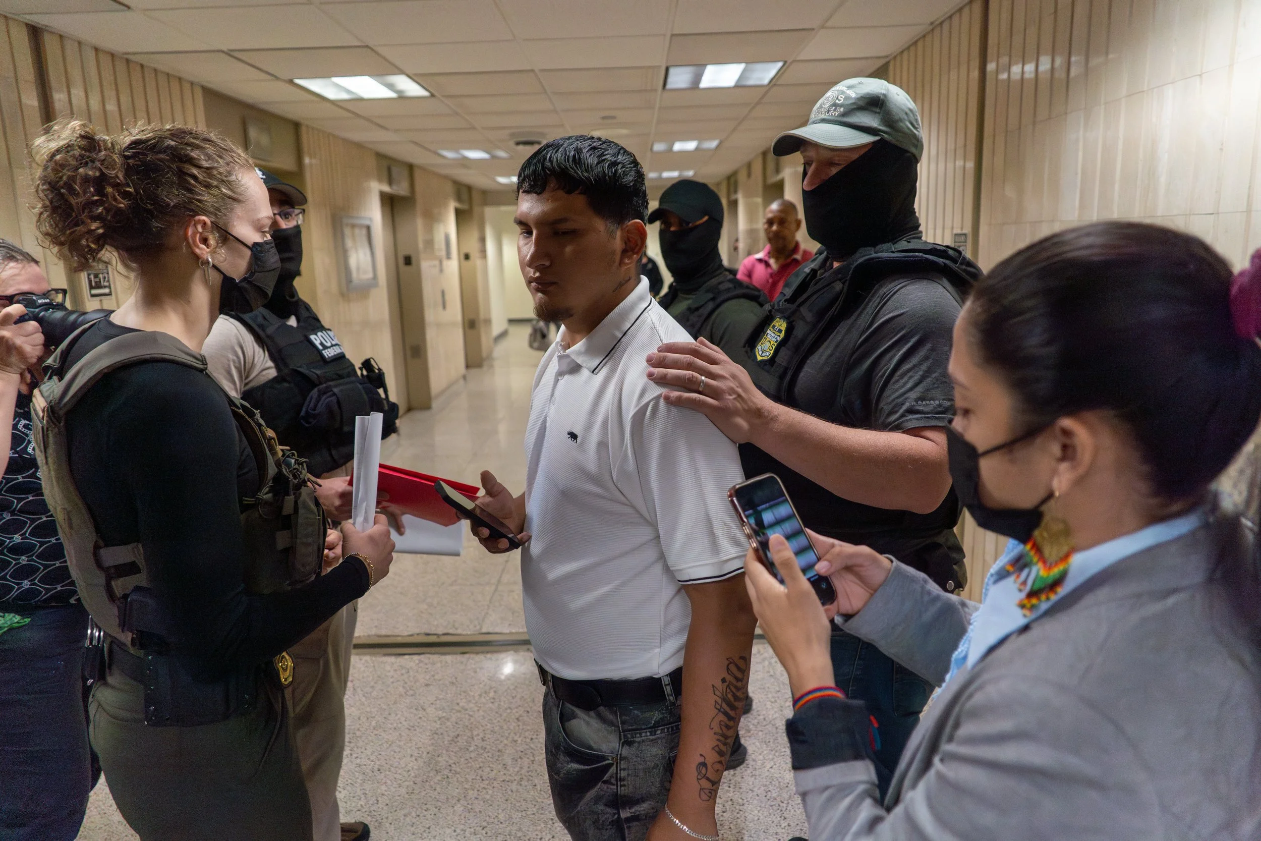 A man is detained by ICE as a court observer steps in, trying to get his wife’s phone number before he’s taken away.