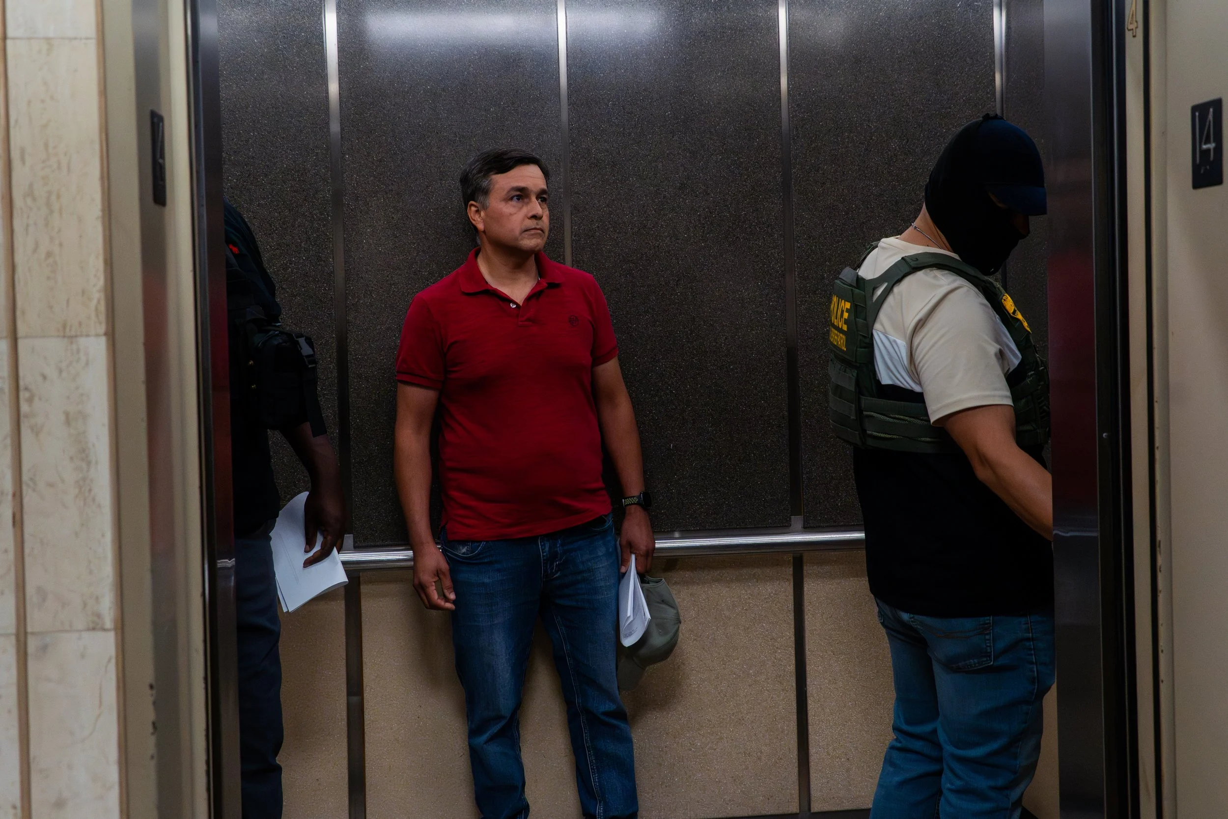 A man on ICE’s list steps into the elevator. Moments later, agents enter behind him without a word. There’s no announcement, no resistance — just the quiet closing of the doors. He will be detained.