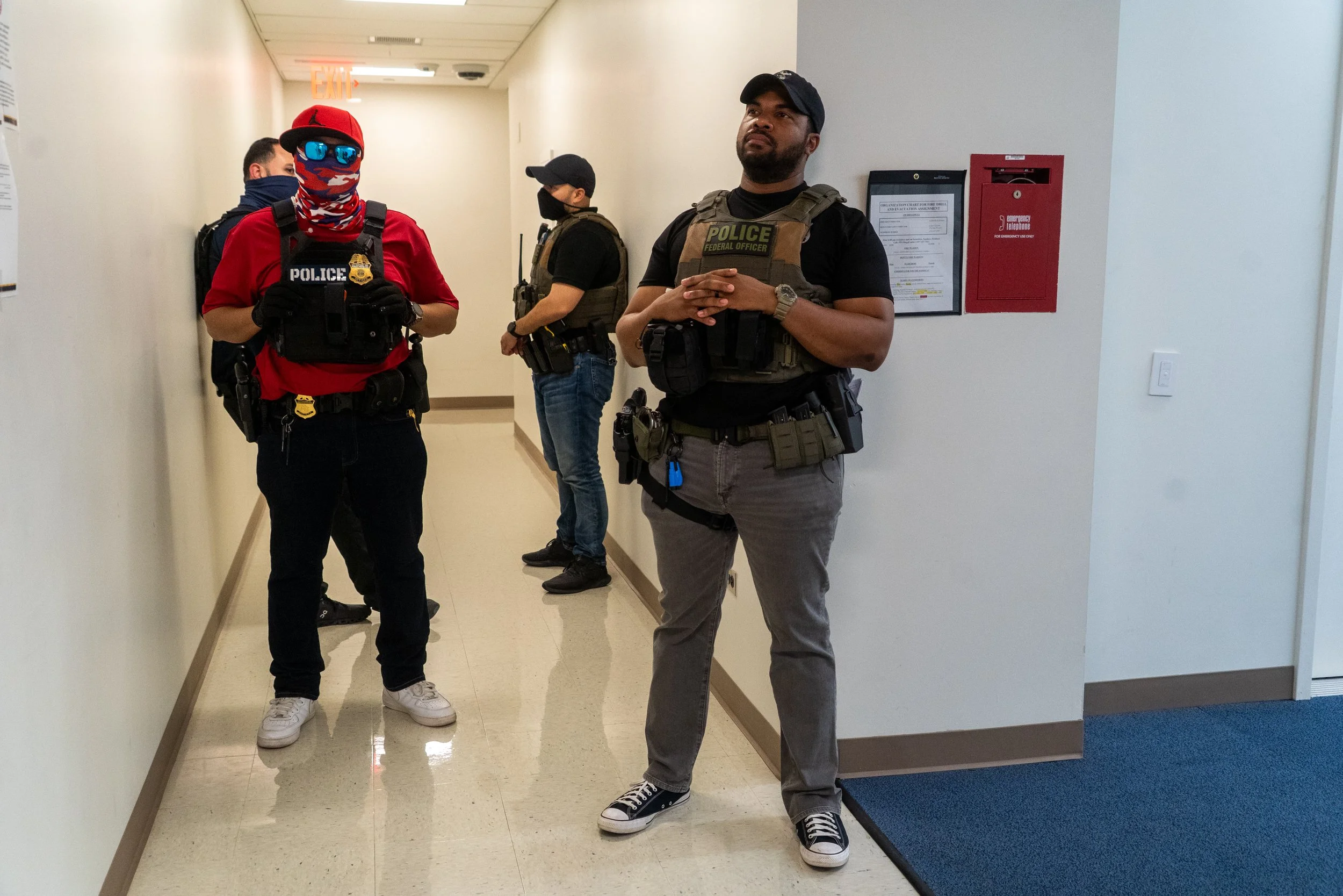 ICE agents stand quietly in the hallway, waiting for immigration court to finish. Once the hearings end, they’ll begin calling names — moving swiftly to detain those on their list.