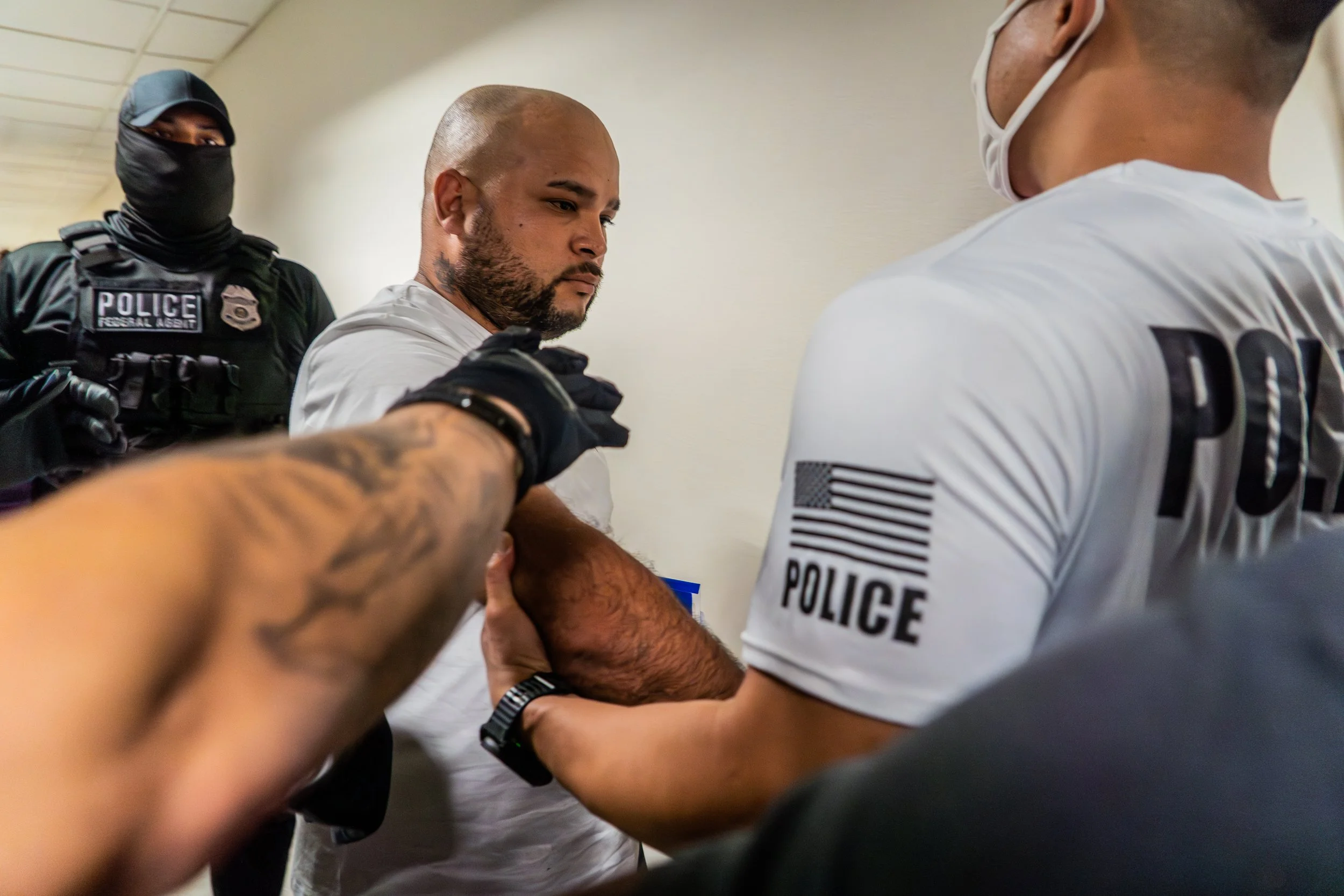 He doesn’t resist. He doesn’t speak. As ICE agents grab hold of him, his expression says everything — a quiet, devastating surrender.