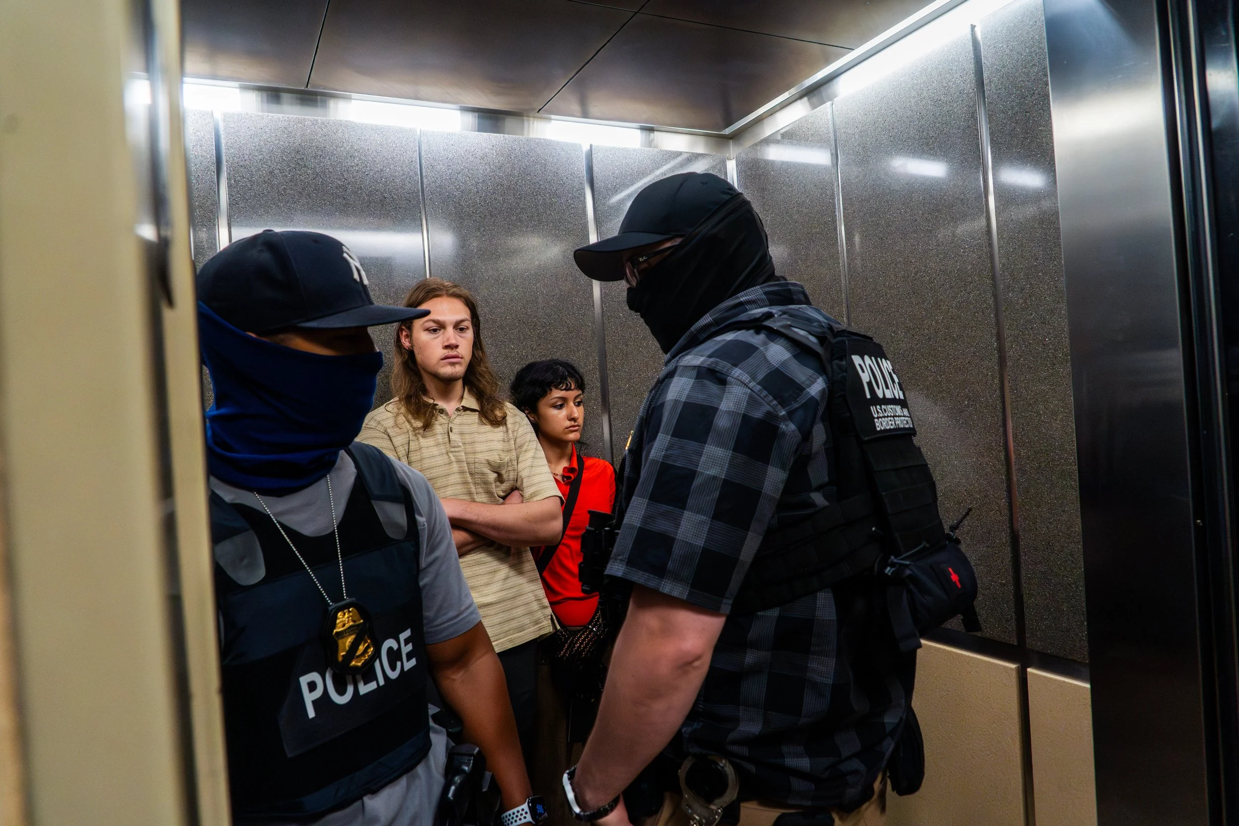 Two court observers ride the elevator beside a man obscured from view — he’s hidden behind an ICE agent. The agents step in without saying a word. There is no announcement, no charge, no exchange. Only silence as the doors slide shut, but he's on t