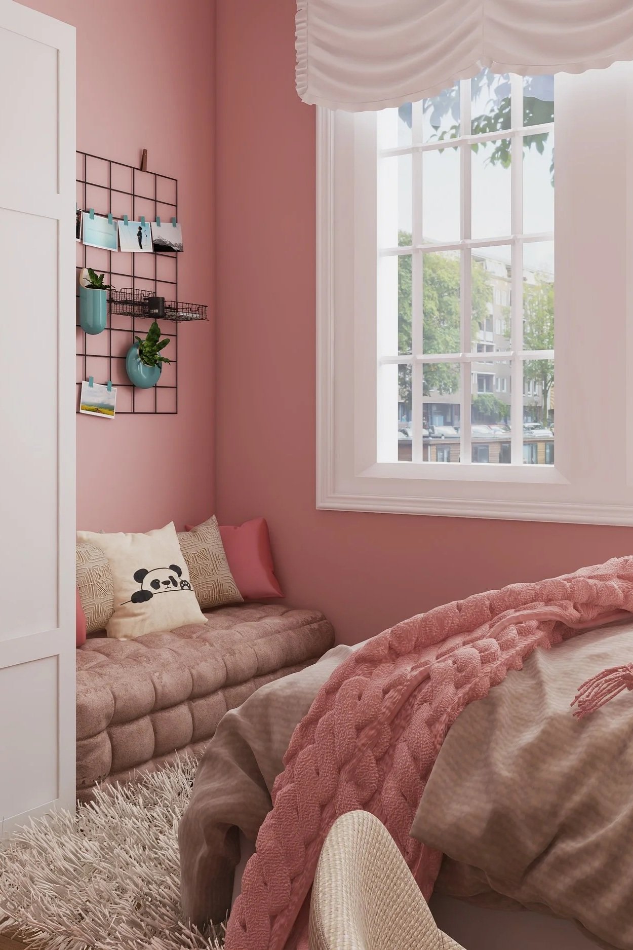A cozy bedroom with pink walls, a large window with white framed panes, a pink tufted bed with a pink blanket, and a beige fuzzy rug. There's a pink sofa with panda and geometric patterned pillows, and a wall grid with photos and small blue planters.
