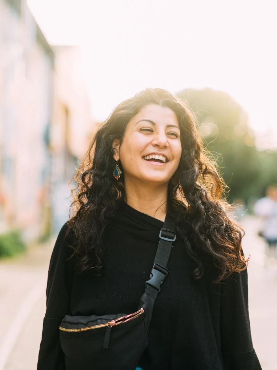 woman with curly hair smiling