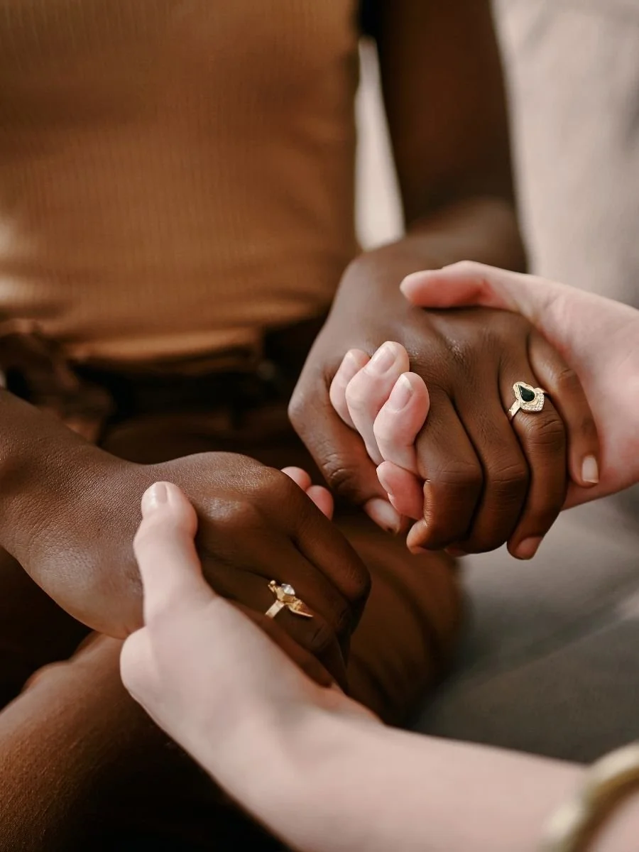 Two women holding hand to try to gain trust