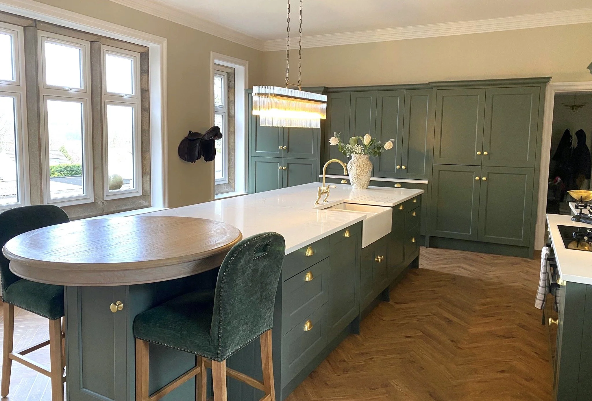The far cabinets are pantry cupboards on the left and bi-fold units in the centre and an integrated fridge/freezer to the right.