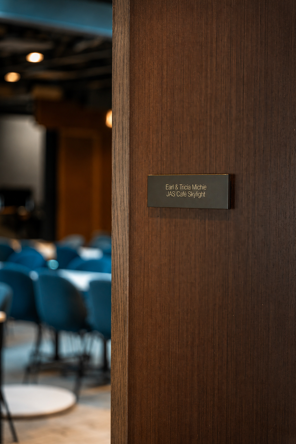 Earl & Tricia Michie JAS Café Skylight donor plaque overlooking café seating Caption: Named donor plaque for the Earl & Tricia Michie JAS Café Skylight at the Paul JAS Center, positioned at the entrance to the café seating area.