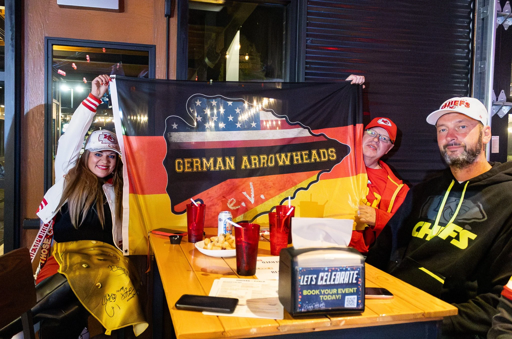 Kansas City Fans hold up a German Arrowheads flag during the live taping of Kansas City Huddle
