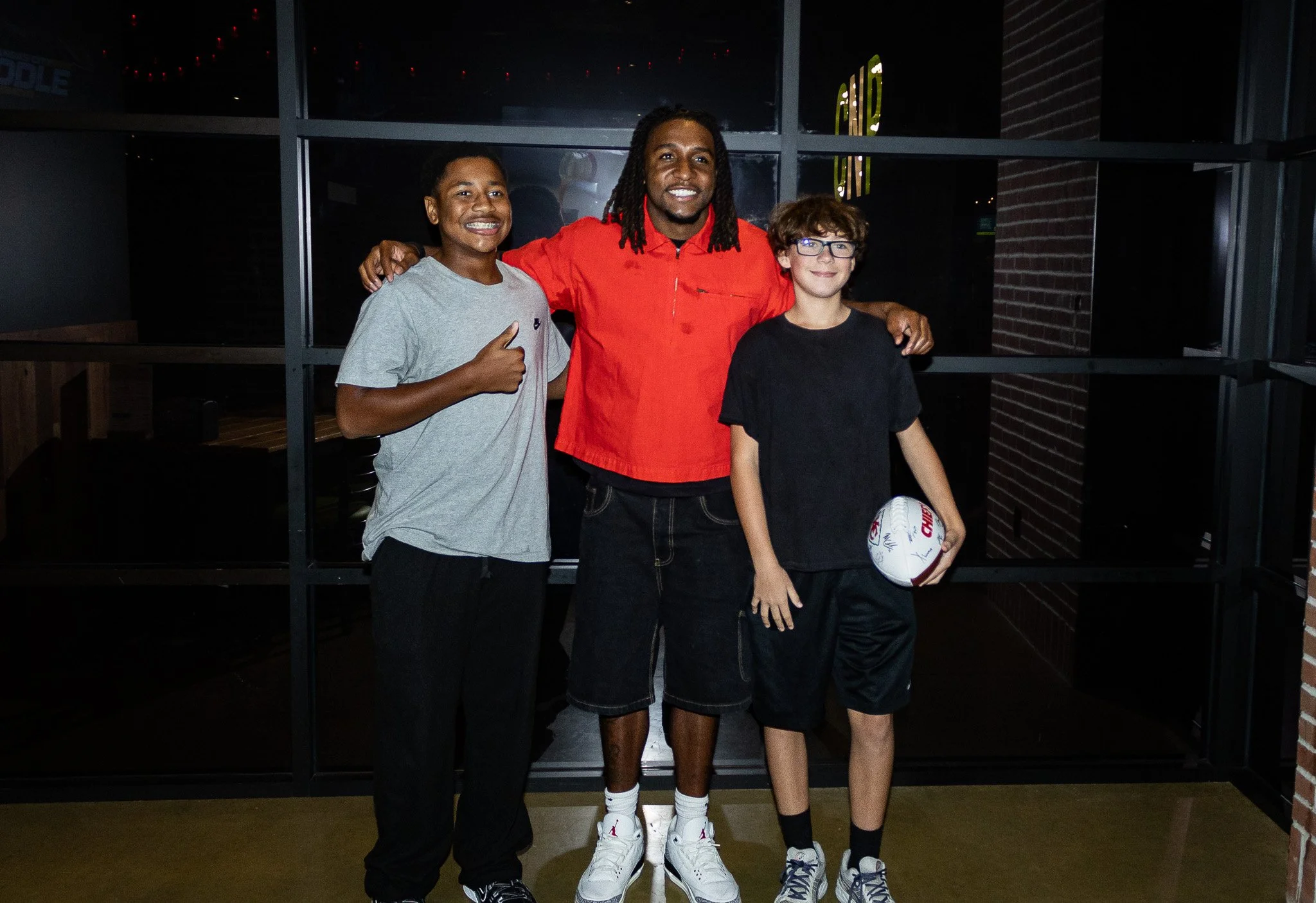 Nohl Williams poses with two fans after Kansas City Huddle live show