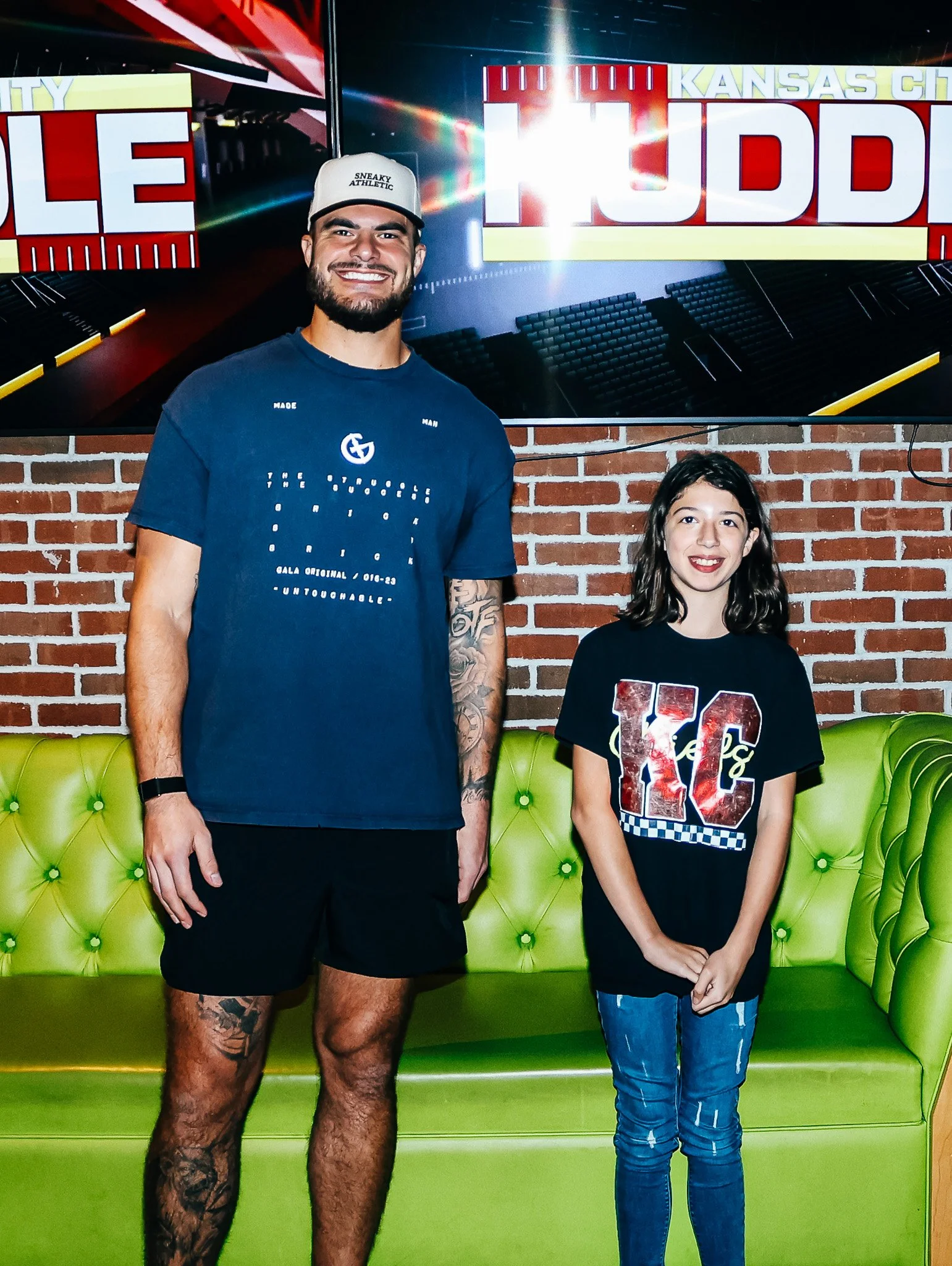 Jared Wiley poses with a fan during the meet & greet for Kansas City Huddle