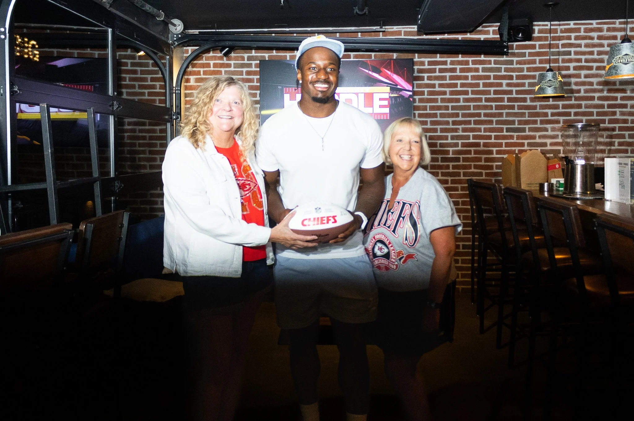 Jeffrey Bassa posing with fans at Kansas City Huddle at Chicken N Pickle