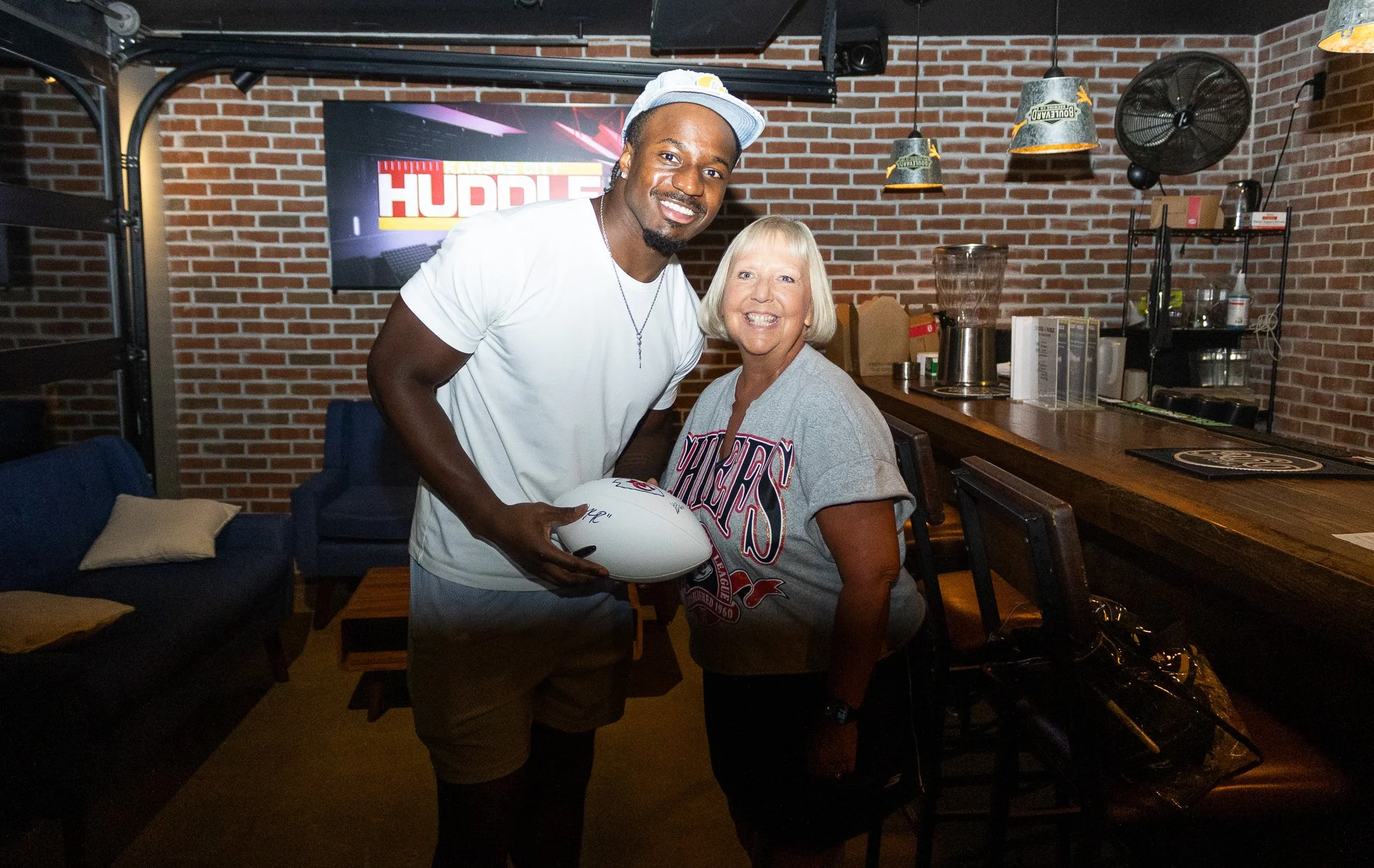 Jeffrey Bassa posing with a fan at Kansas City Huddle at Chicken N Pickle