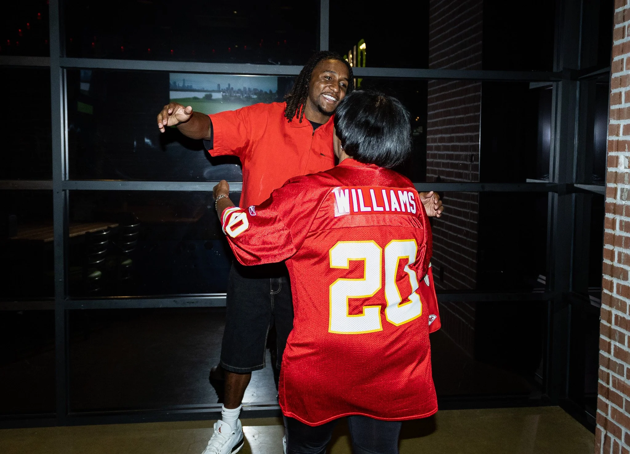 Nohl Williams hugs a fan during the meet & Greet following the live show of Kansas City Huddle