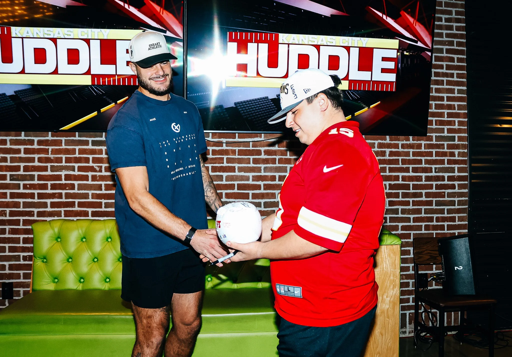 Jared Wiley meets a Kansas City fan during the live taping of Kansas City Huddle at Chicken N Pickle Overland Park