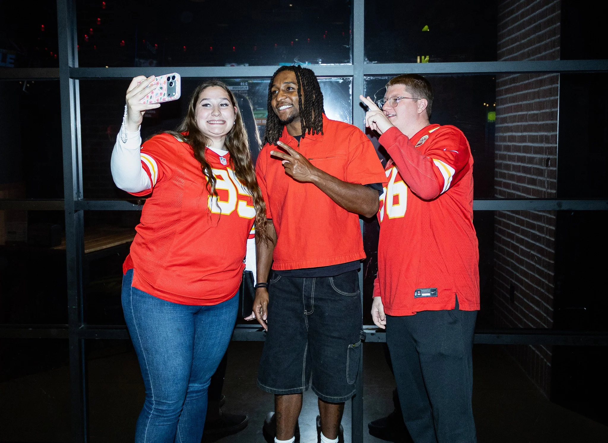 Nohl Williams takes a selfie with 2 fans during the meet & greet at Kansas City Huddle