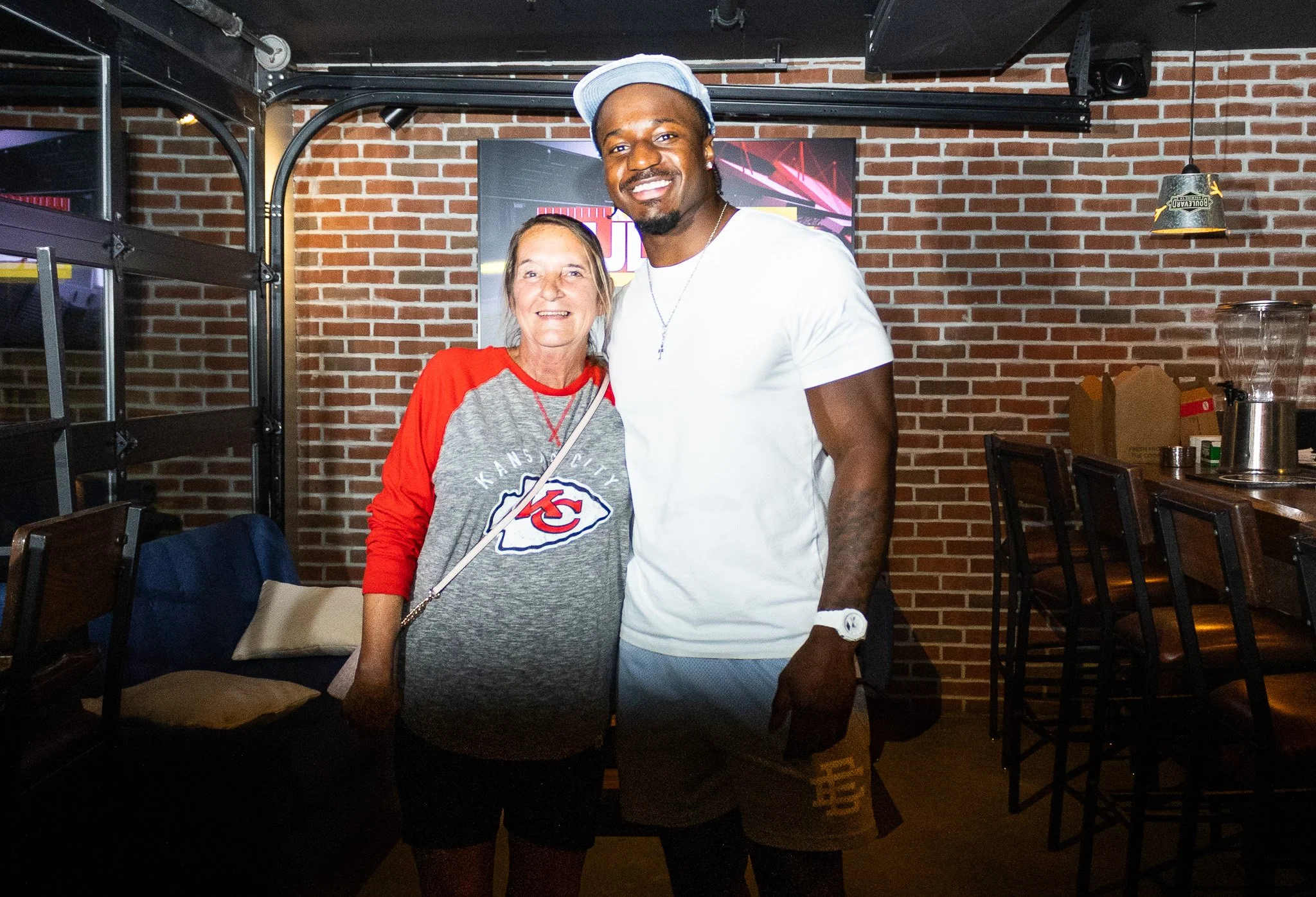 Jeffrey Bassa posing with a fan at Kansas City Huddle at Chicken N Pickle
