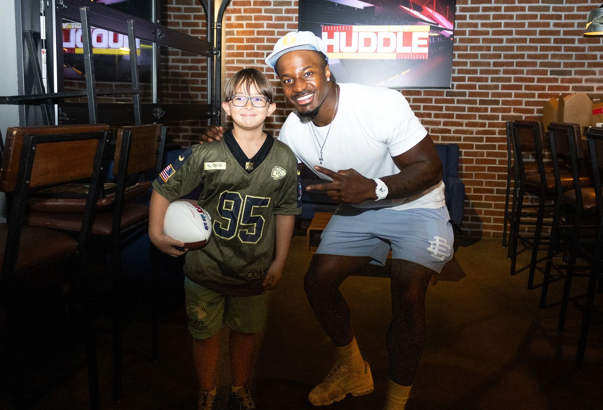 Jeffrey Bassa posing with a fan at Kansas City Huddle at Chicken N Pickle