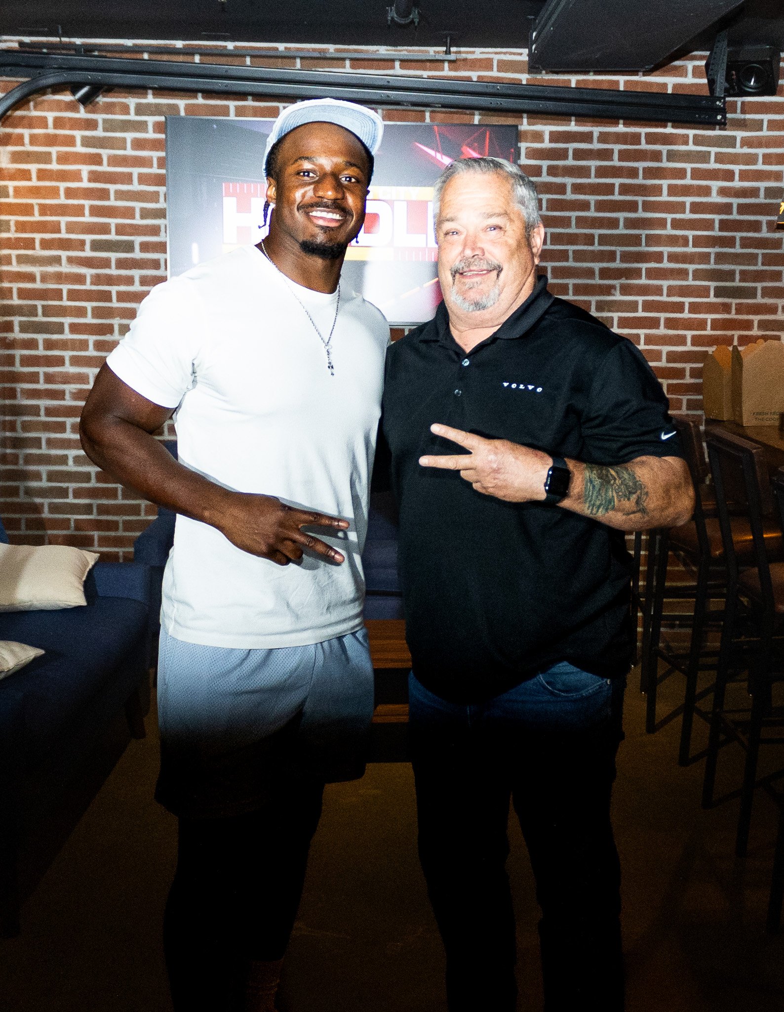 Jeffrey Bassa posing with a fan at Kansas City Huddle at Chicken N Pickle
