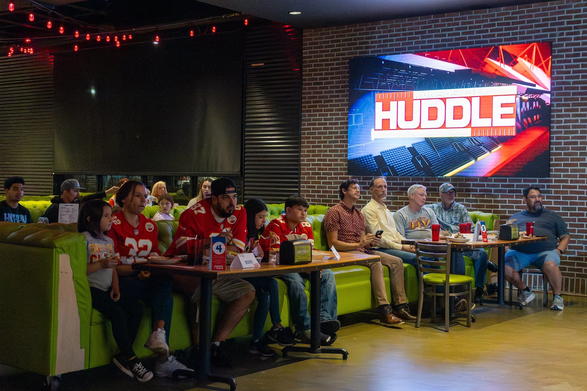 Kansas City football fans attend the live Kansas City Huddle show featuring Jared Wiley.