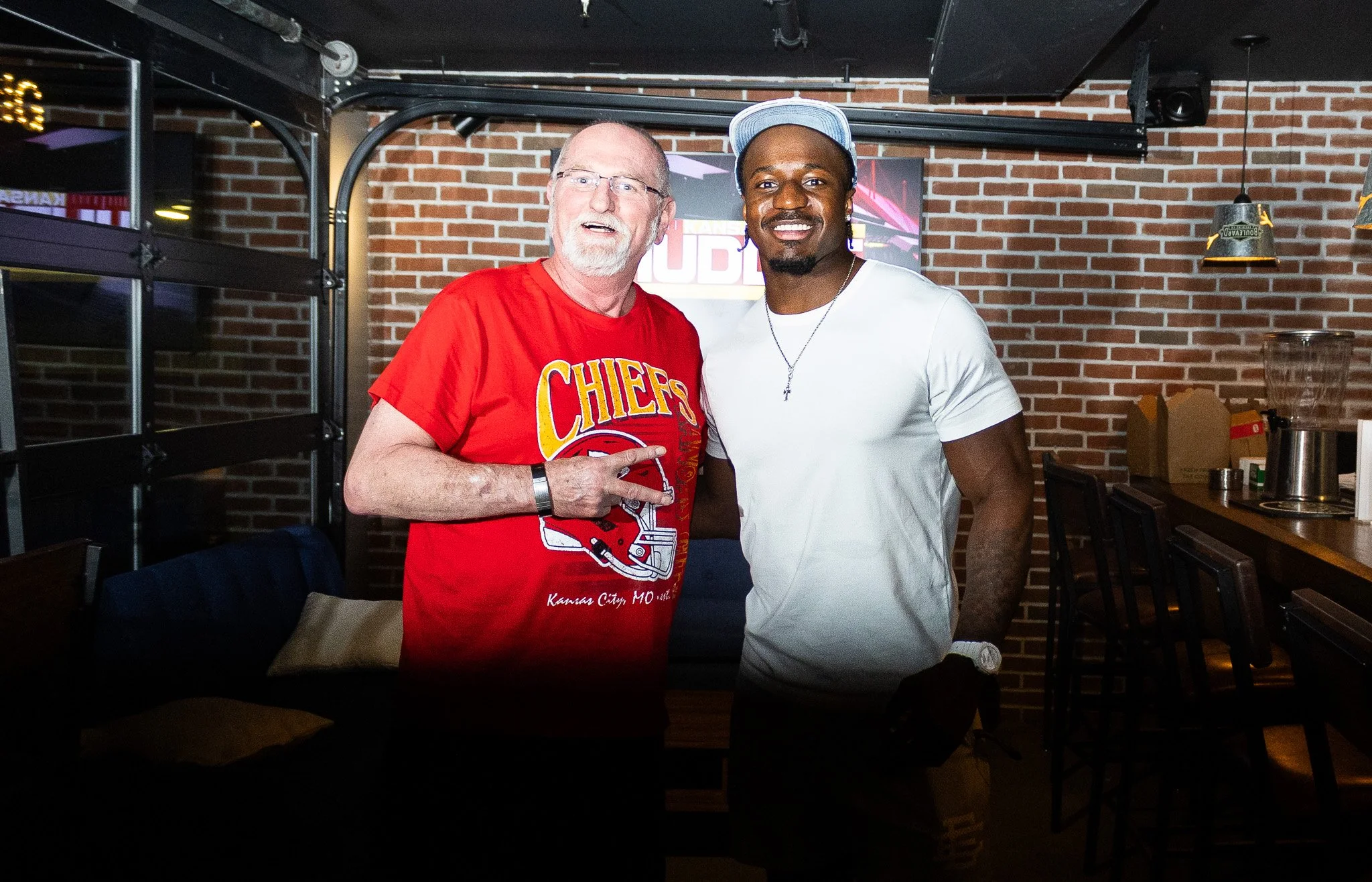 Jeffrey Bassa posing with a fan at Kansas City Huddle at Chicken N Pickle