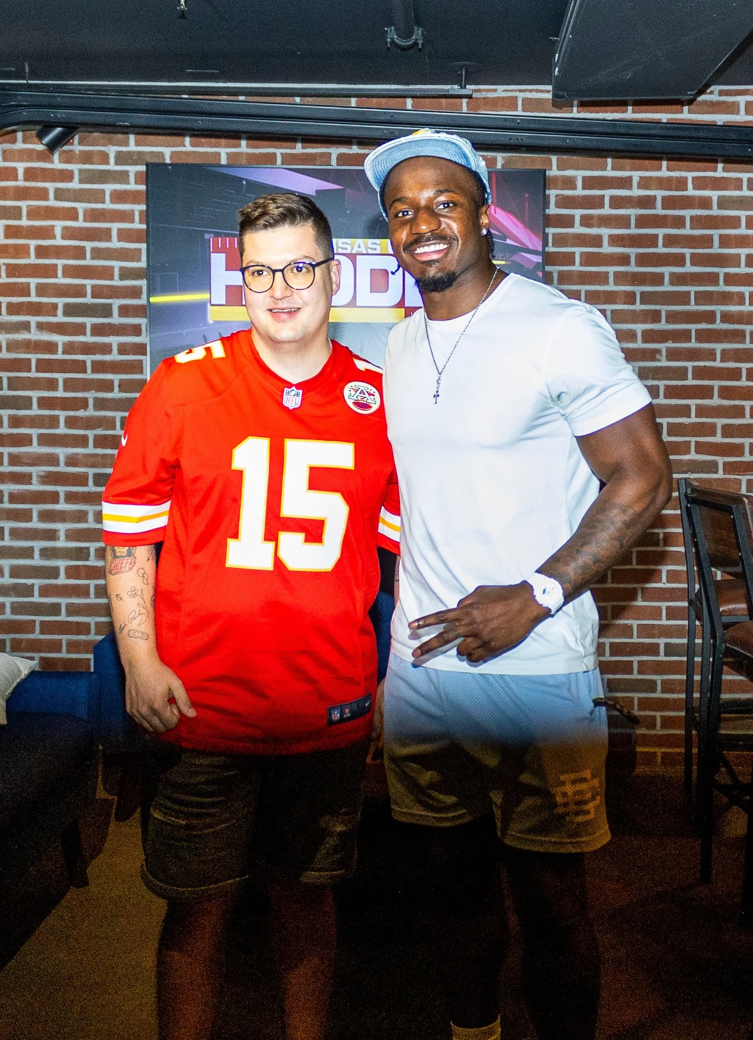 Jeffrey Bassa posing with a fan at Kansas City Huddle at Chicken N Pickle