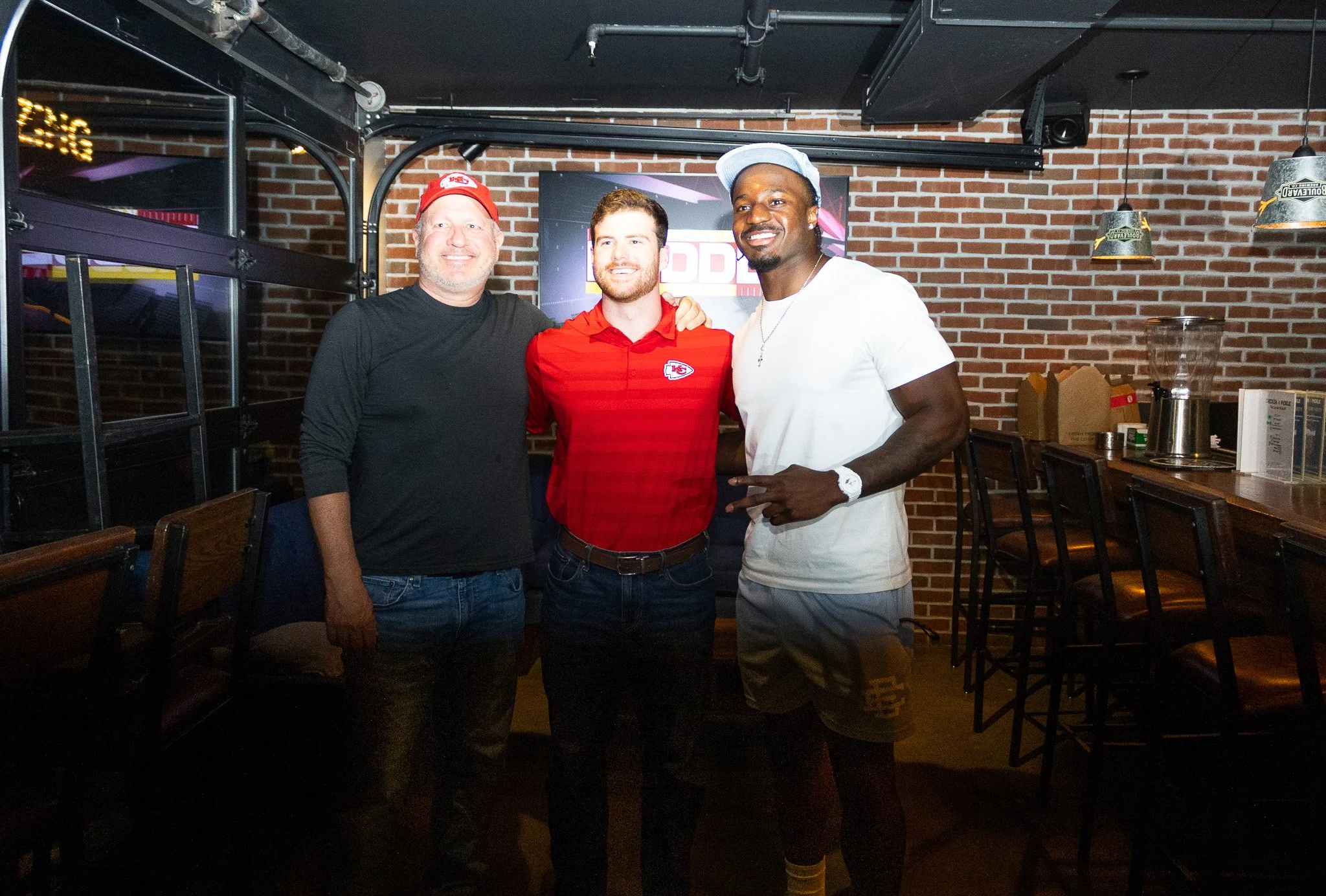 Jeffrey Bassa posing with fans at Kansas City Huddle at Chicken N Pickle