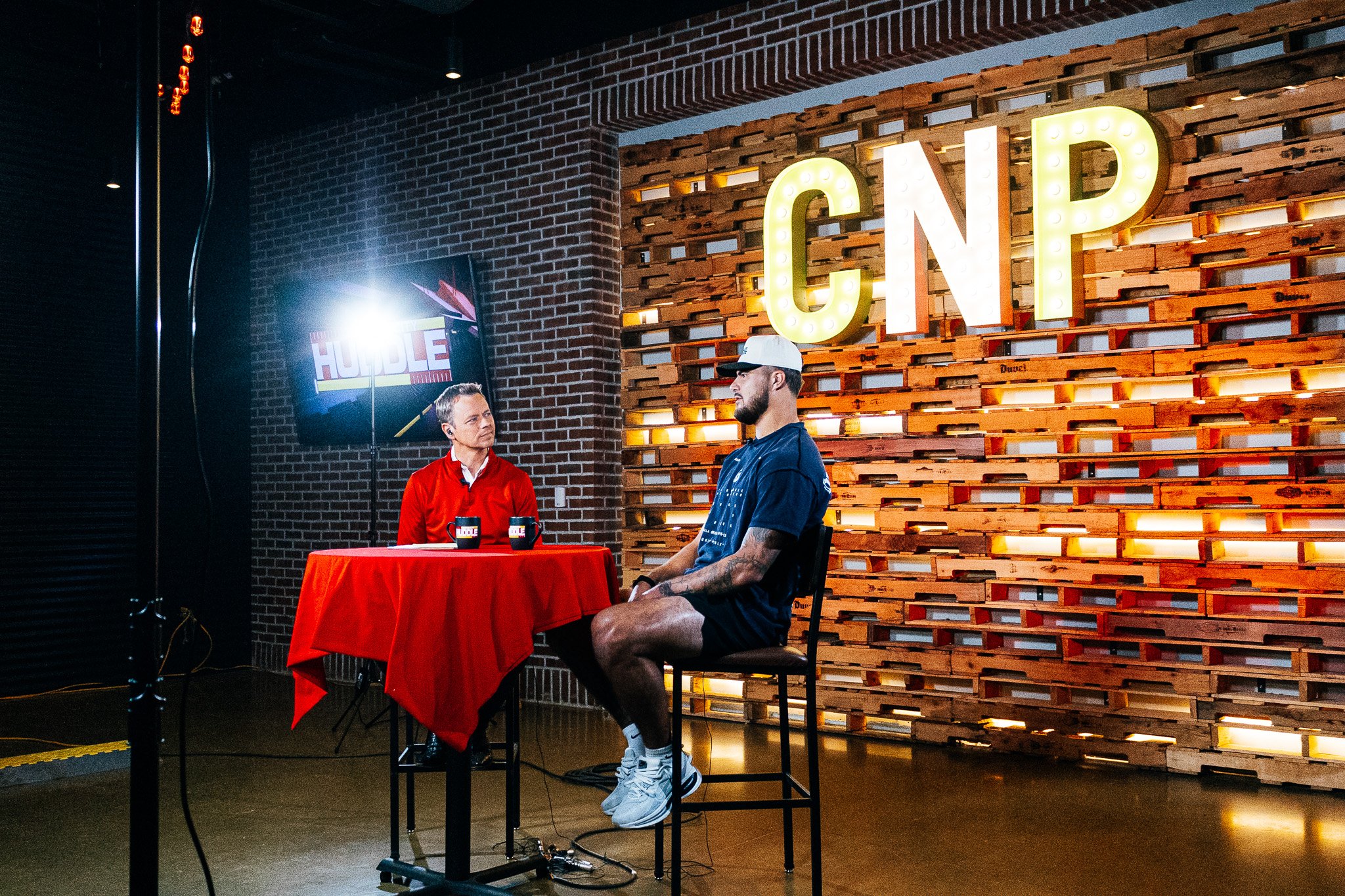 Jared Wiley and FOX4 host Rob Collins share the stage during a live Kansas City Huddle episode.