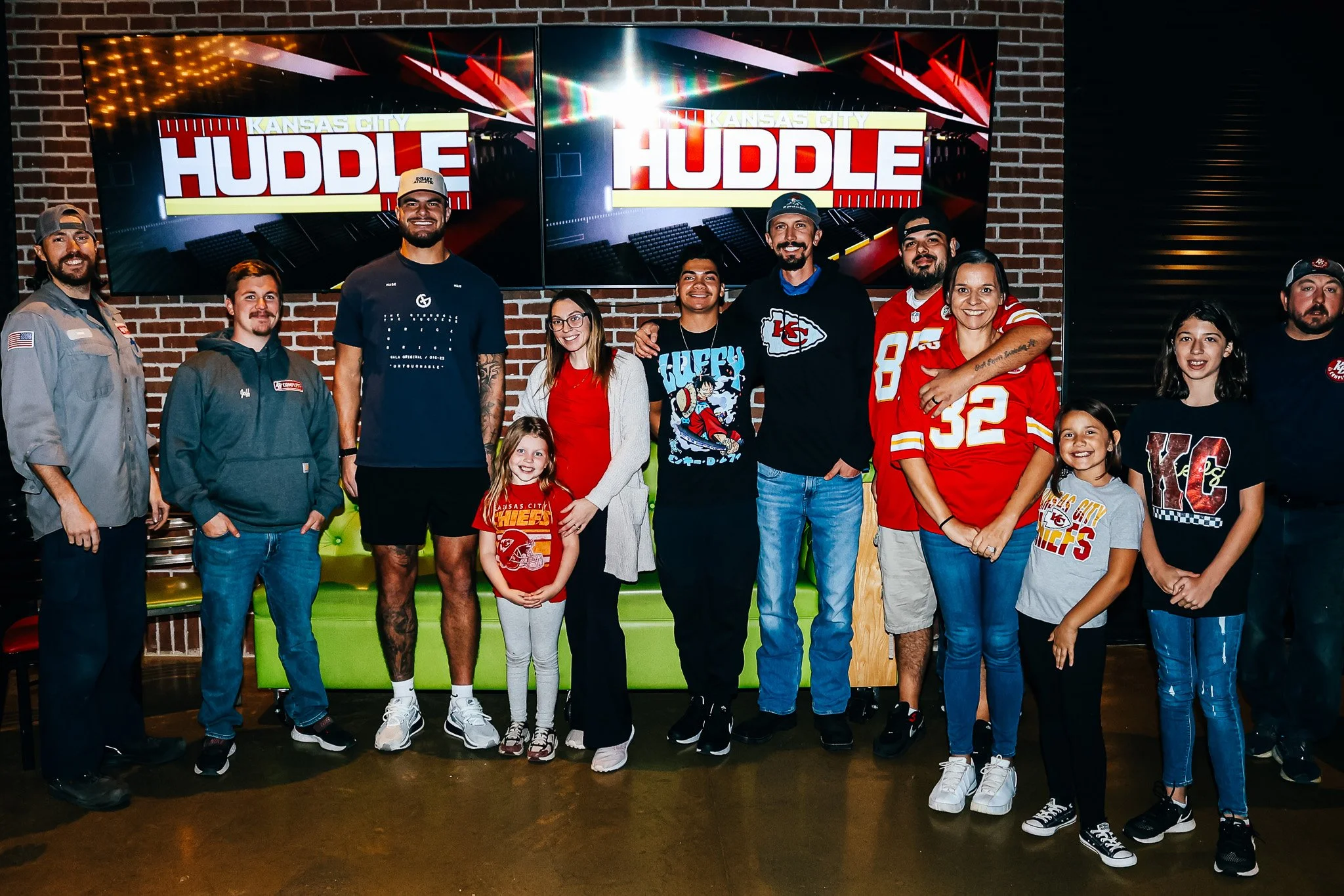 Jared Wiley poses with a group of fans during the meet & greet for Kansas City Huddle.