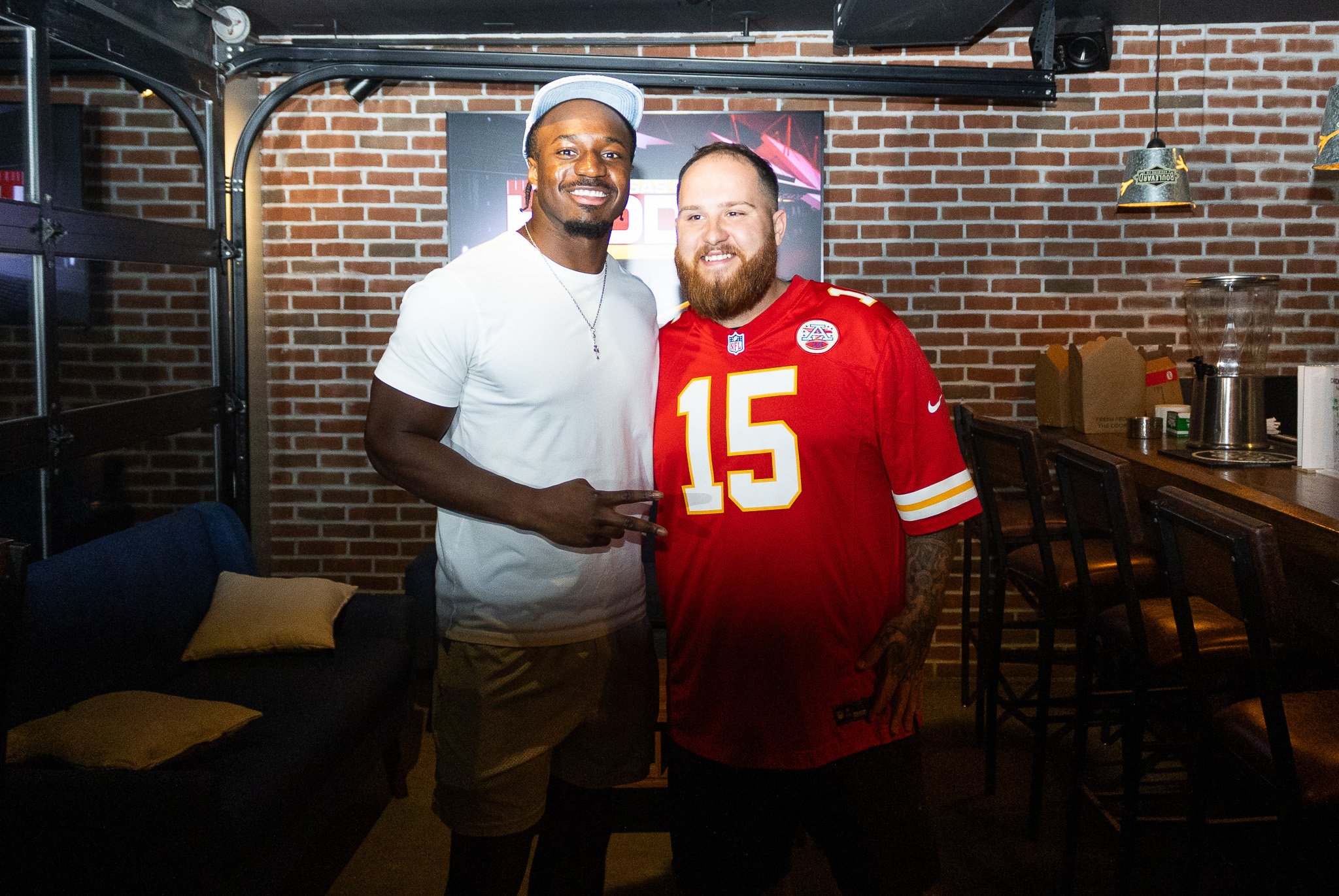 Jeffrey Bassa posing with a fan at Kansas City Huddle at Chicken N Pickle