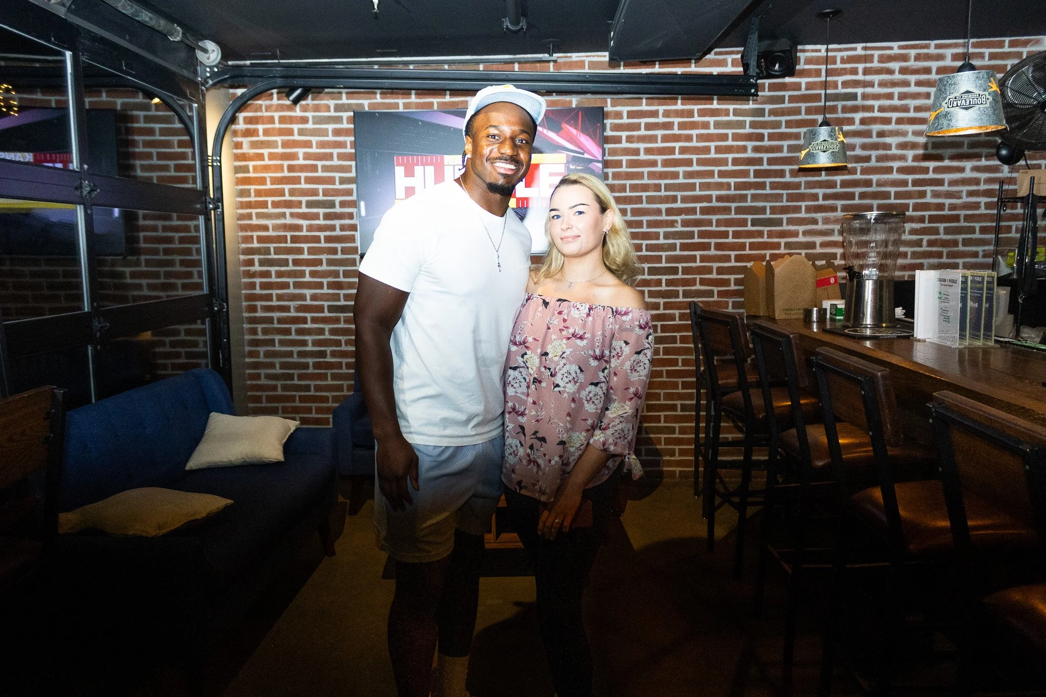 Jeffrey Bassa posing with a fan at Kansas City Huddle at Chicken N Pickle
