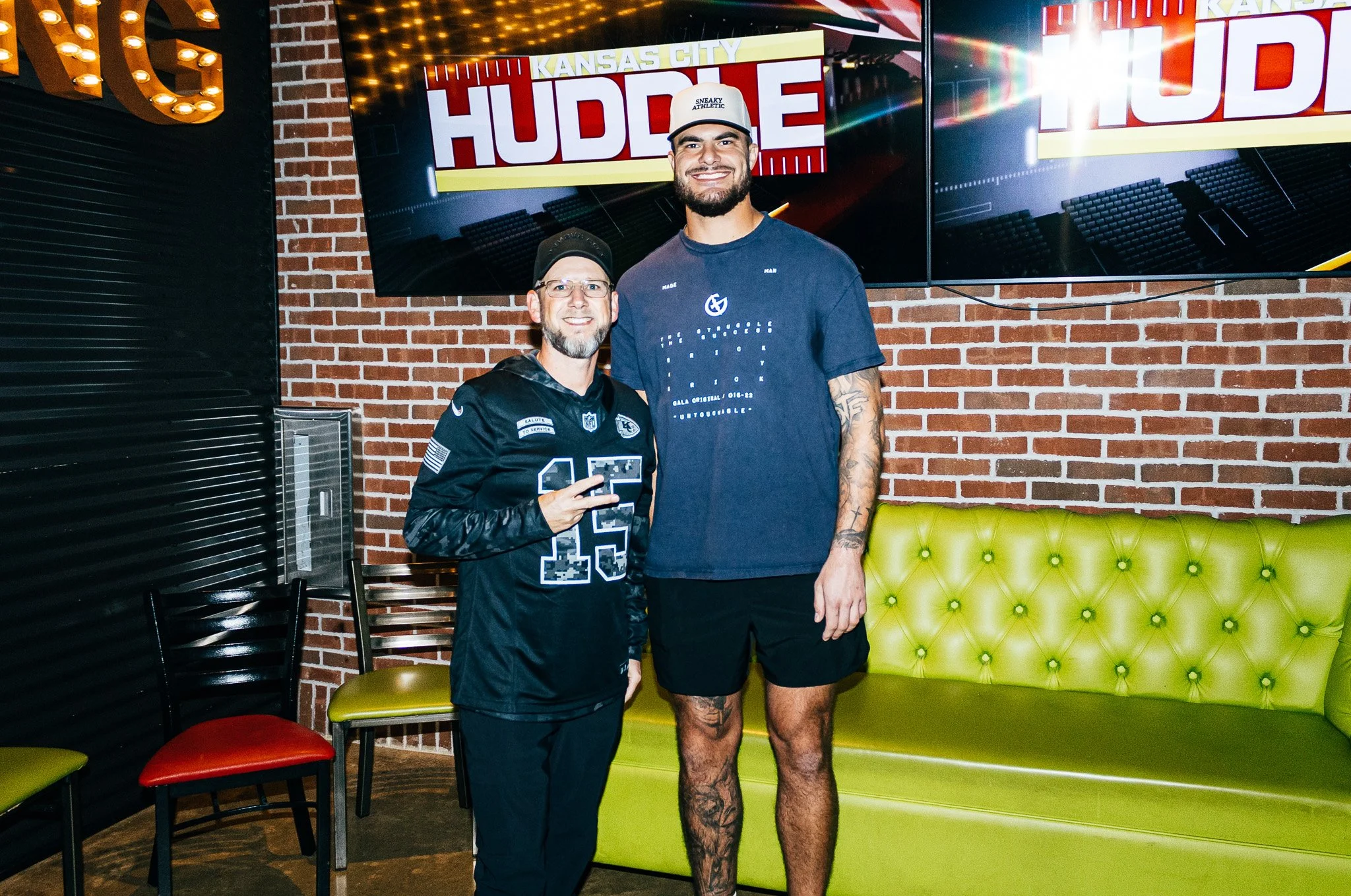 Jared Wiley poses with a fan during the meet & greet for Kansas City Huddle