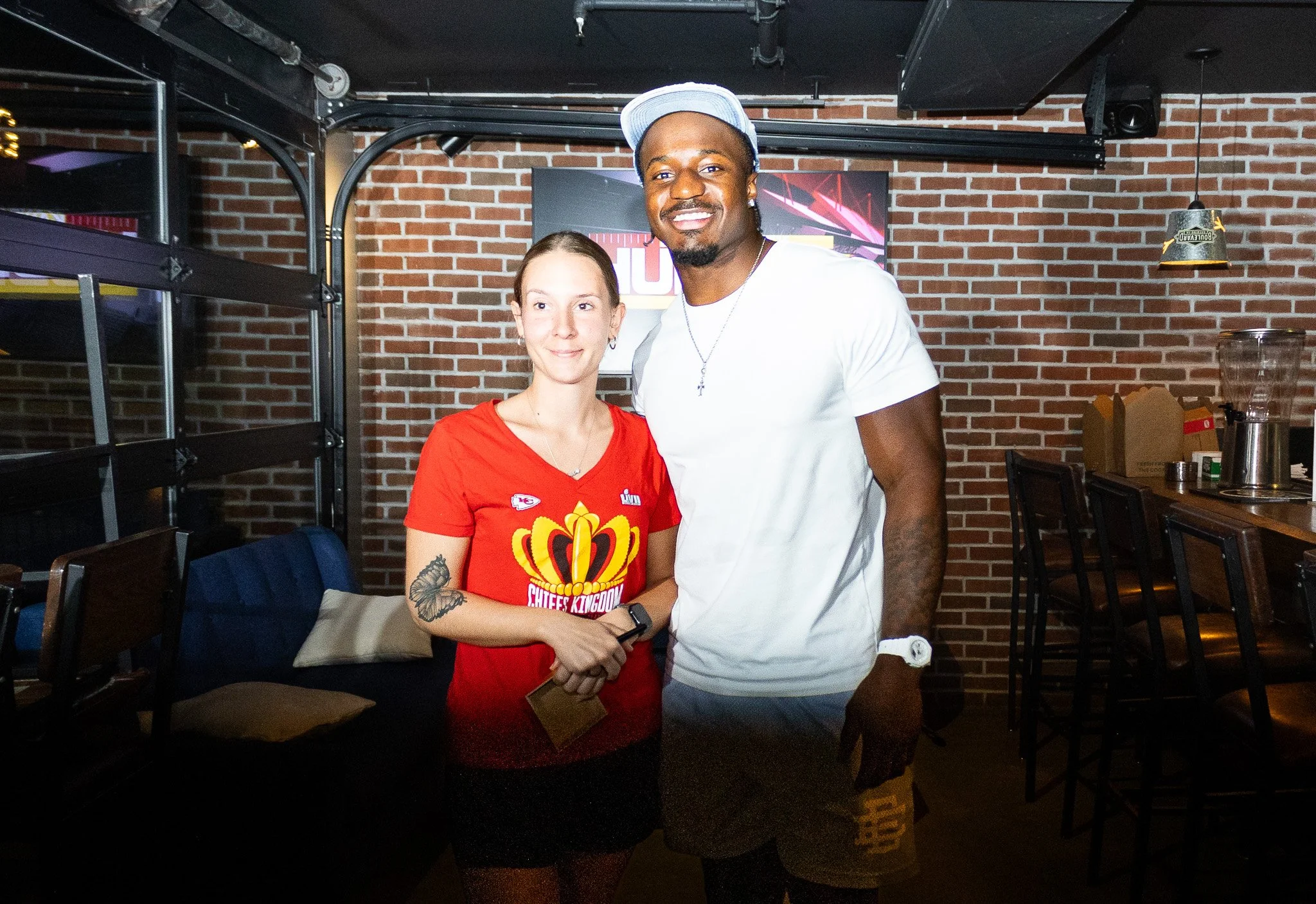 Jeffrey Bassa posing with a fan at Kansas City Huddle at Chicken N Pickle