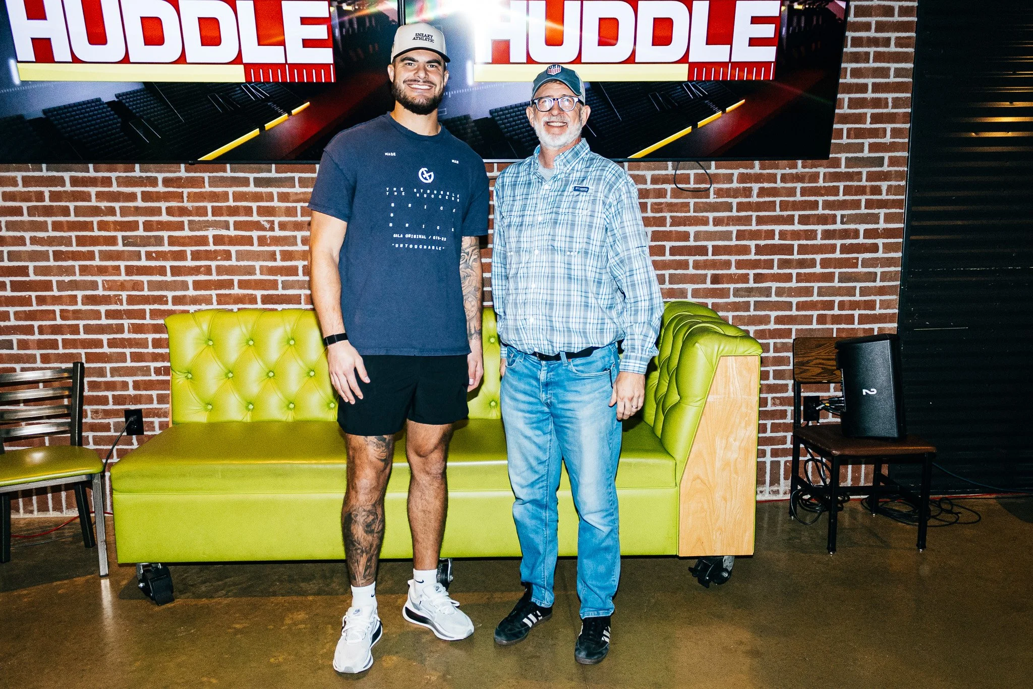 Jared Wiley poses with a fan during the meet & greet for Kansas City Huddle