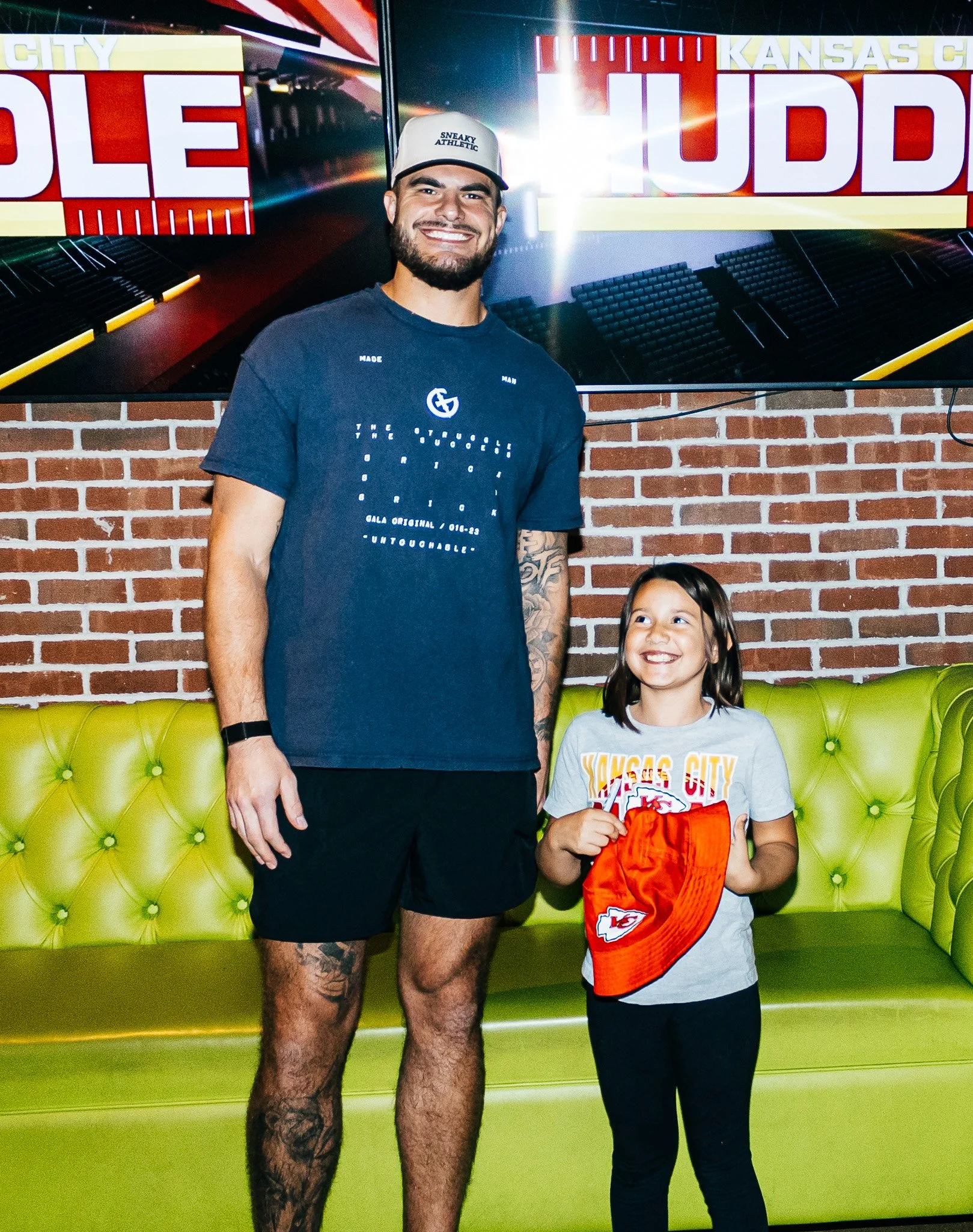 Jared Wiley poses with a fan during the meet & greet for Kansas City Huddle