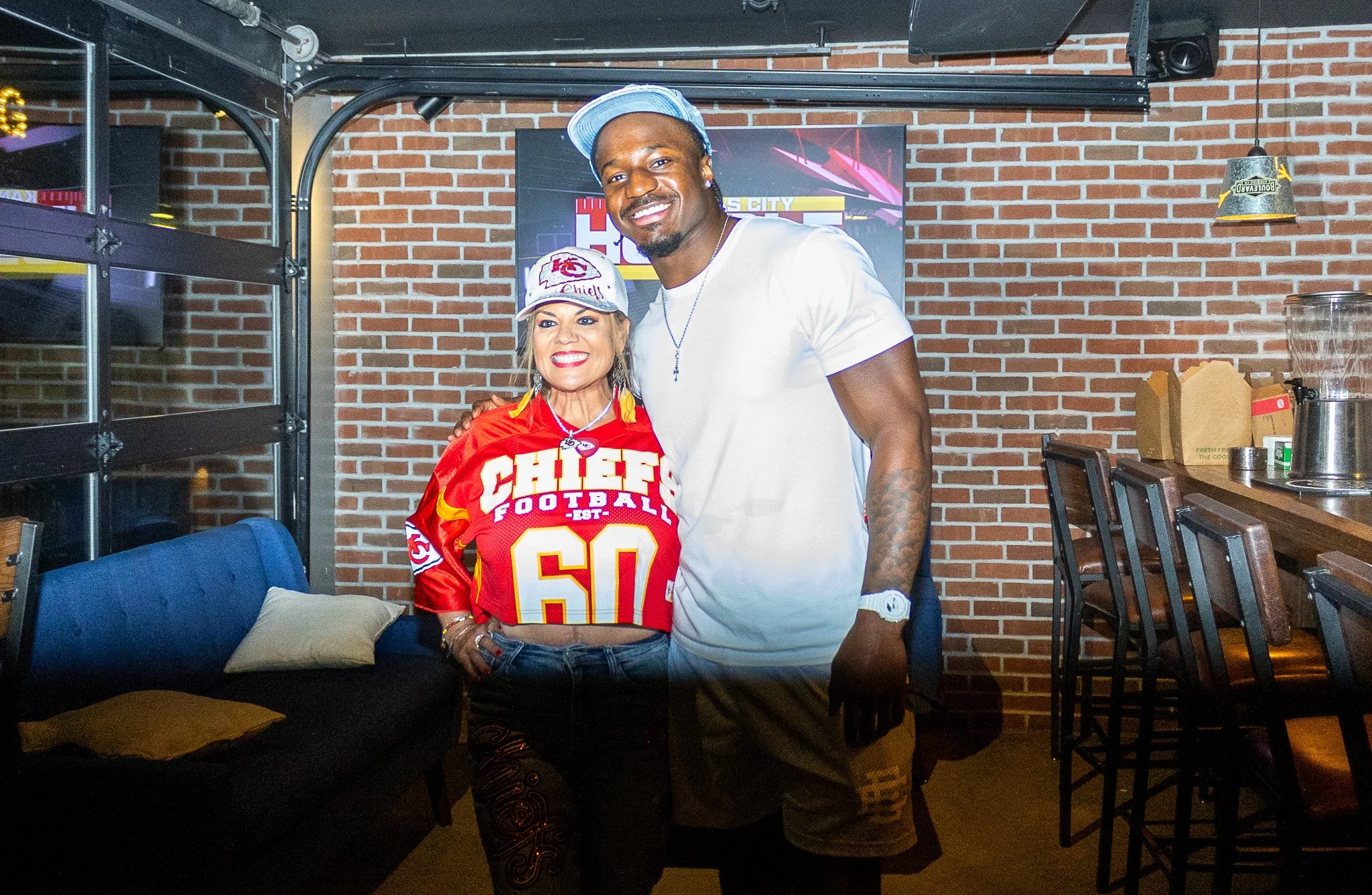 Jeffrey Bassa posing with a fan at Kansas City Huddle at Chicken N Pickle